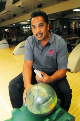 Dan Buena, bowling center manager, shows off the center's new remote-controlled bowling ball. U. S. Air Force photo by Sue Sapp