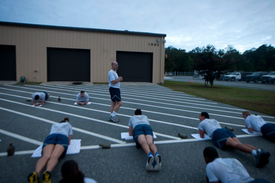 U.S. Air Force Senior Mater Sgt. Philip Borneman, 820th Combat Operation Squadron superintendent, motivates his Airmen to not quit and finish strong during Sergeant Rock physical training (PT) at Moody Air Force Base Ga., Sept. 6, 2011. Borneman and PT leaders for the 820th Base Defense Group constantly motivated every Airmen participating in Sergeant Rock PT to keep morale and attitudes high throughout the session. (U.S. Air Force photo by Airman 1st Class Joshua Green/Released)                  
         
