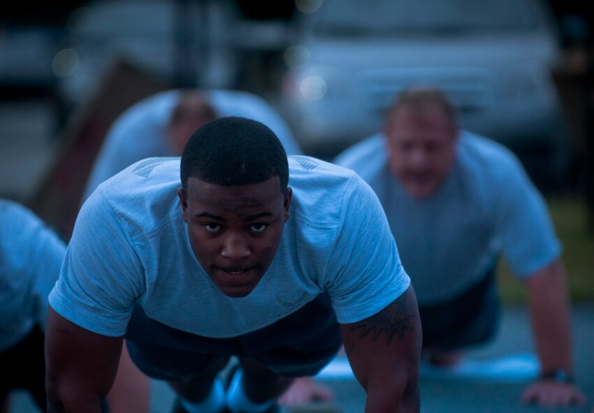 U.S. Air Force Airman 1st Class Derrick Allen, 820th Combat Operation Squadron intelligence analyst, focuses while performing pushups during Sergeant Rock physical training (PT) at Moody Air Force Base Ga., Sept. 6, 2011. Since the program has been implemented, 820th Base Defense Group Airmen have improved on both the situp and pushup portions of their PT test. (U.S. Air Force photo by Airman 1st Class Joshua Green/Released)        
