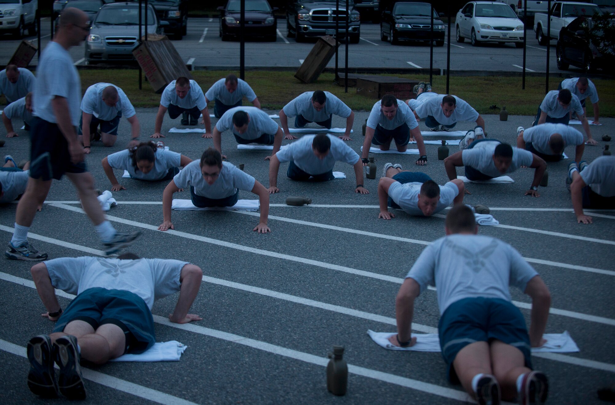 U.S. Air Force Airmen from the 820th Base Defense Group (BDG) perform wide arm pushups during Sergeant Rock physical training at Moody Air Force Base Ga., Sept. 6, 2011. Sergeant Rock PT was put in place to help individuals improve their physical strength and mental toughness. Its goal is to help condition 95 percent of the BDG to score above a 95 percent on their PT test. (U.S. Air Force photo by Airman 1st Class Joshua Green/Released)    
