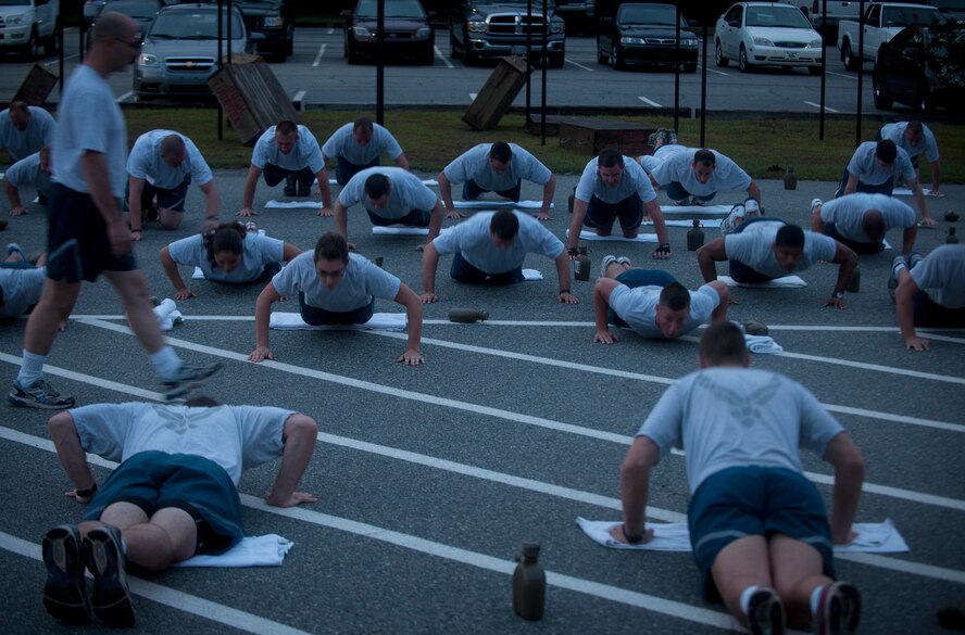 U.S. Air Force Airmen from the 820th Base Defense Group (BDG) perform wide arm pushups during Sergeant Rock physical training at Moody Air Force Base Ga., Sept. 6, 2011. Sergeant Rock PT was put in place to help individuals improve their physical strength and mental toughness. Its goal is to help condition 95 percent of the BDG to score above a 95 percent on their PT test. (U.S. Air Force photo by Airman 1st Class Joshua Green/Released)    
