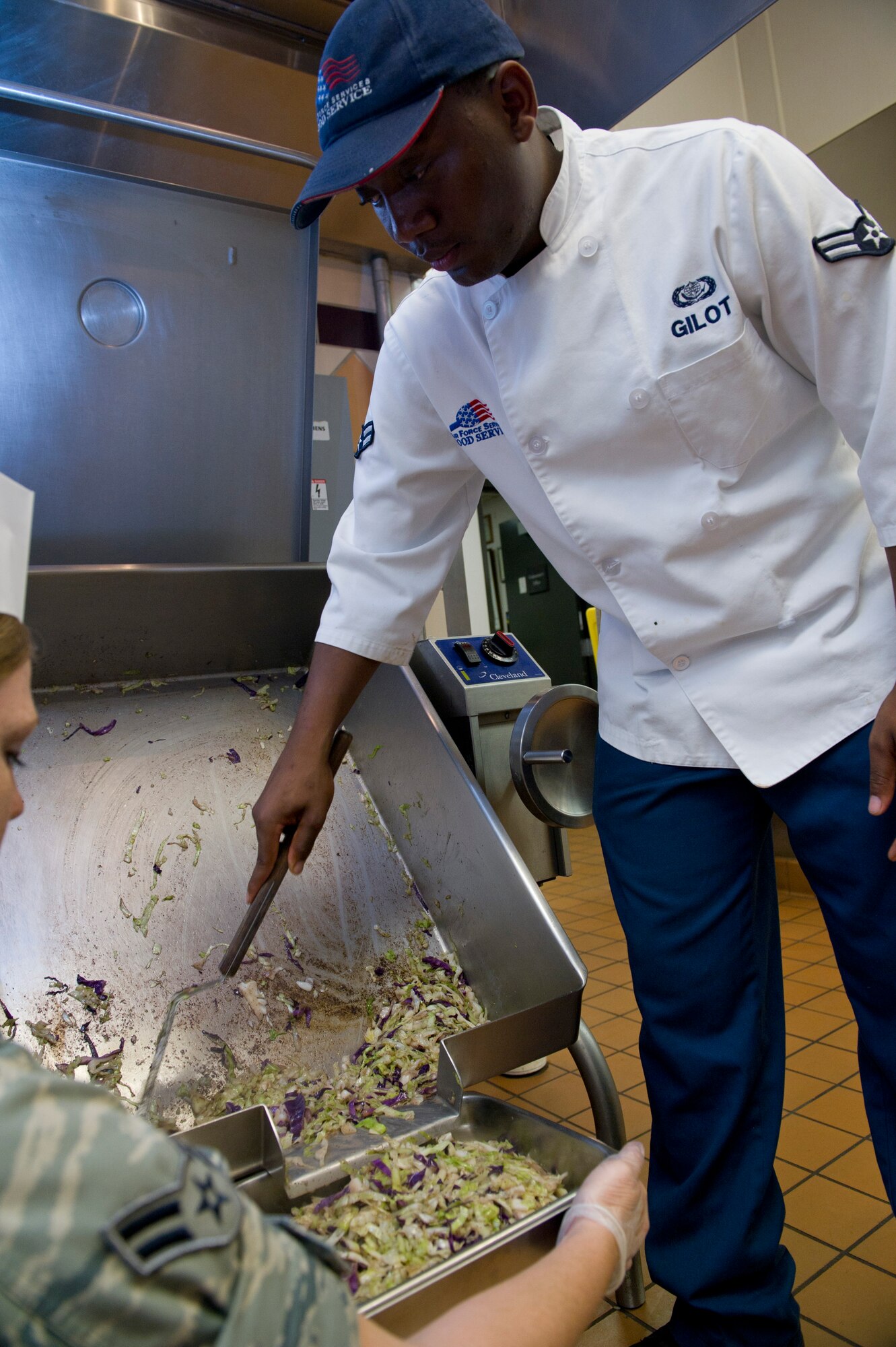 HOLLOMAN AIR FORCE BASE, N.M. -- U.S. Air Force Airman 1st Class Jeffrey Gilot, 49th Force Support Squadron food handler, gathers fried cabbage onto a tray in preparation for dinner at the Shifting Sands Dining Facility Aug. 31, 2011. Gilot was awarded Chef of the Quarter after winning a cook-off competition, and was given the opportunity to cook alongside chefs at Stella Vita, a local restaurant. (U.S. Air Force photo by Senior Airman Veronica Stamps/Released))