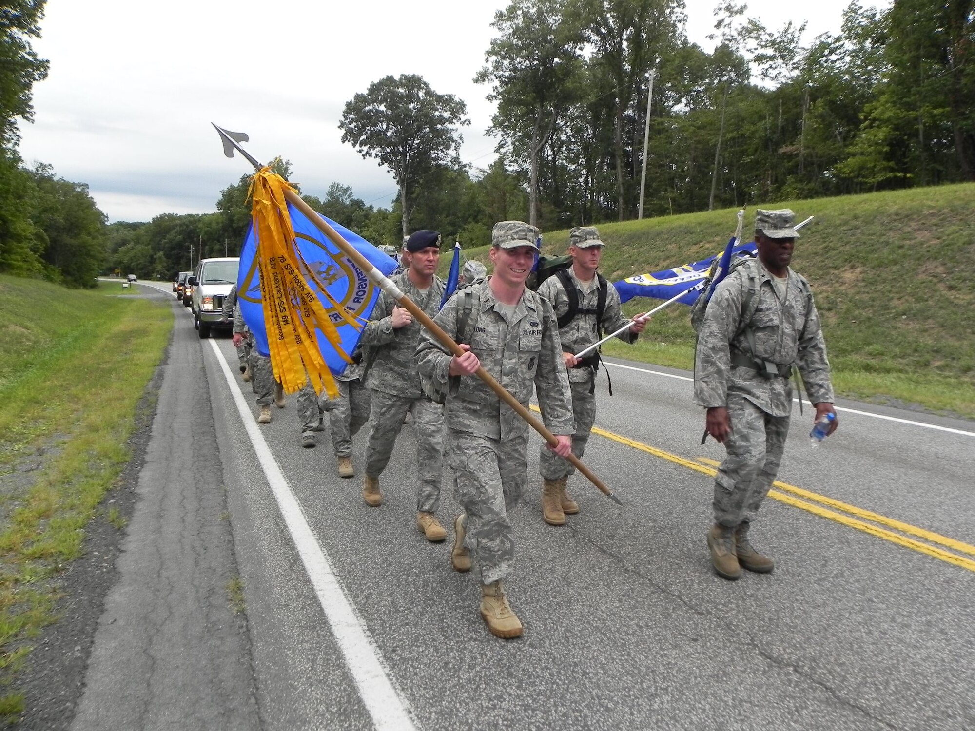 Brig. Gen. Jimmy McMillian, headquarters director of Security Forces, and 2nd Lt. Sean Long, 11th Security Forces Squadron flight commander, lead the way during the Ruck March to Remember.  Team Andrews defenders marched the guidon more than 150 miles from West Virginia to Pennsylvania. (courtesy photo)