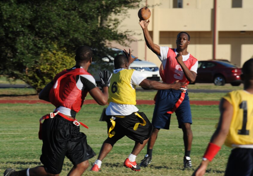 Airman 1st Class Broderick Knox, 2nd Dental Squadron, throws a football to his teammate during an intramural flag football game between the 2nd Logistics Readiness Squadron and the 2 DS on Barksdale Air Force Base, La., Sept. 6. The Barksdale Health and Wellness Center offers intramural leagues to help raise fitness and boost unit morale. (U.S. Air Force photo/Airman 1st Class Micaiah Anthony)(RELEASED)