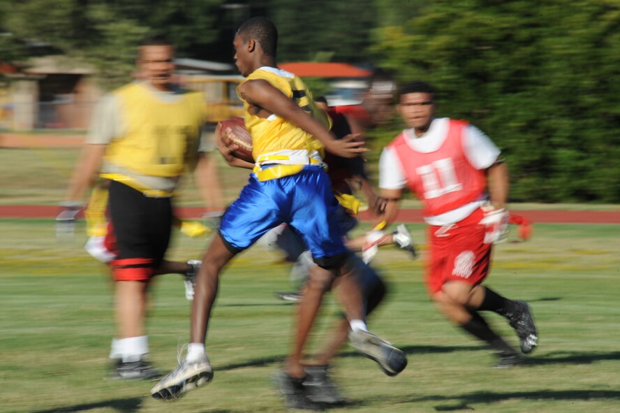 Airman 1st Class Patrick Martin, 2nd Logistics Readiness Squadron, evades defenders from the 2nd Dental Squadron during an intramural flag football game on Barksdale Air Force Base, La., Sept. 6. The Barksdale Health and Wellness Center offers intramural leagues to help raise fitness and boost unit morale. (U.S. Air Force photo/Airman 1st Class Micaiah Anthony)(RELEASED)