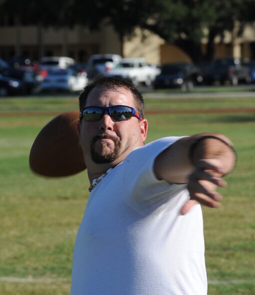 Michael Copeland, husband of Tech. Sgt. Mary Copeland, 2nd Dental Squadron, prepares to throw a football during warm-ups for an intramural flag football game on Barksdale Air Force Base, La., Sept. 6. Spouses of military members are allowed to join their spouse?s unit team for intramural sports. (U.S. Air Force photo/Airman 1st Class Micaiah Anthony)(RELEASED)  