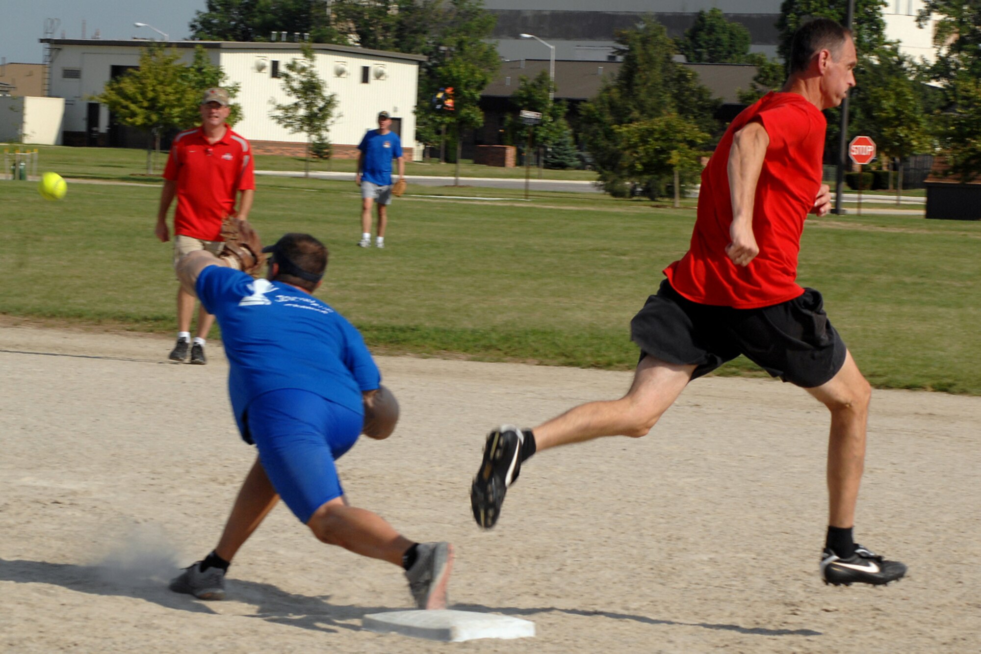 GRISSOM AIR RESERVE BASE, Ind. -- Marty Foye makes it to first base before Jim West can catch the ball for an out during the 5th Annual Jovanovich Cup Aug. 13. Every year the Fightin' Red Tags and the Dark Side battle it out for the trophy and bragging rights. This year the Red Tags edged the Dark Siders, 13-12. The event is held in memory of Lt. Col. George Jovanovich who died in a car accident in March 2006. (U.S. Air Force photo/Senior Airman Jami K. Lancette)