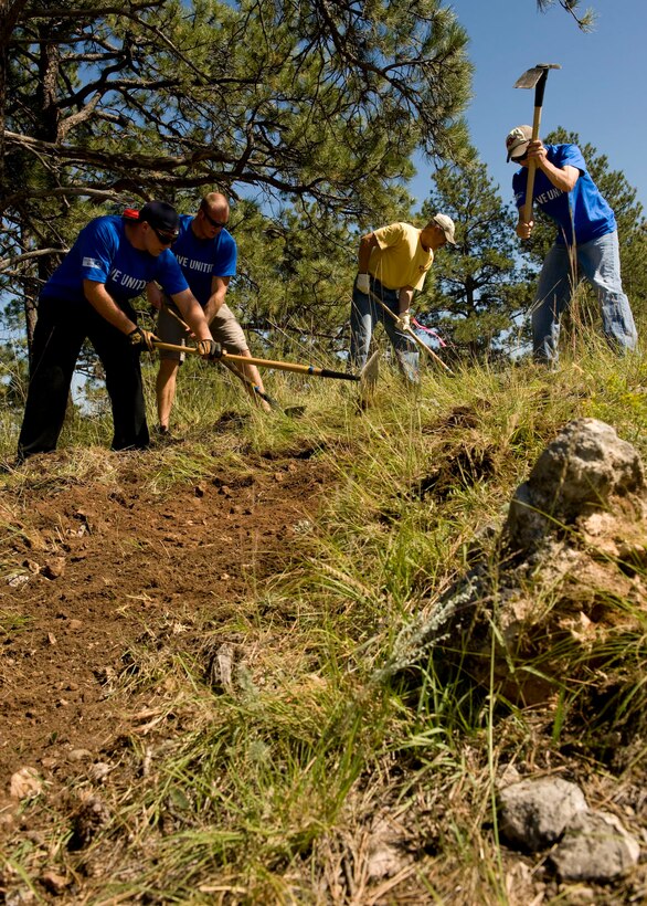 Volunteers from the 28th Munitions Squadron make a walking path at the Rapid City YMCA’s Giraffic Park in Hermosa, S.D., Sept. 1, 2011. Seventeen Airmen from the 28th Munitions Squadron teamed up with a handful of civilians, completed projects during the Rapid City United Way Day of Caring. (U.S. Air Force photo by Airman 1st Class Kate Thornton/Released)