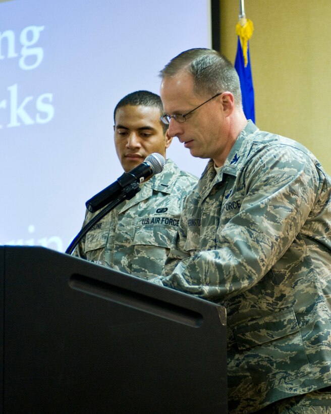 Col. Mark Weatherington, 28th Bomb Wing commander, signs his Combined Federal Campaign donation form during the CFC kickoff breakfast at Ellsworth Air Force Base, S.D., Sept. 6, 2011. Anyone donating has the choice to give to any local, national, or international charity by simply filling out a donation form and giving it to their nearest CFC office. (U.S. Air Force photo by Airman Alystria Maurer/Released)