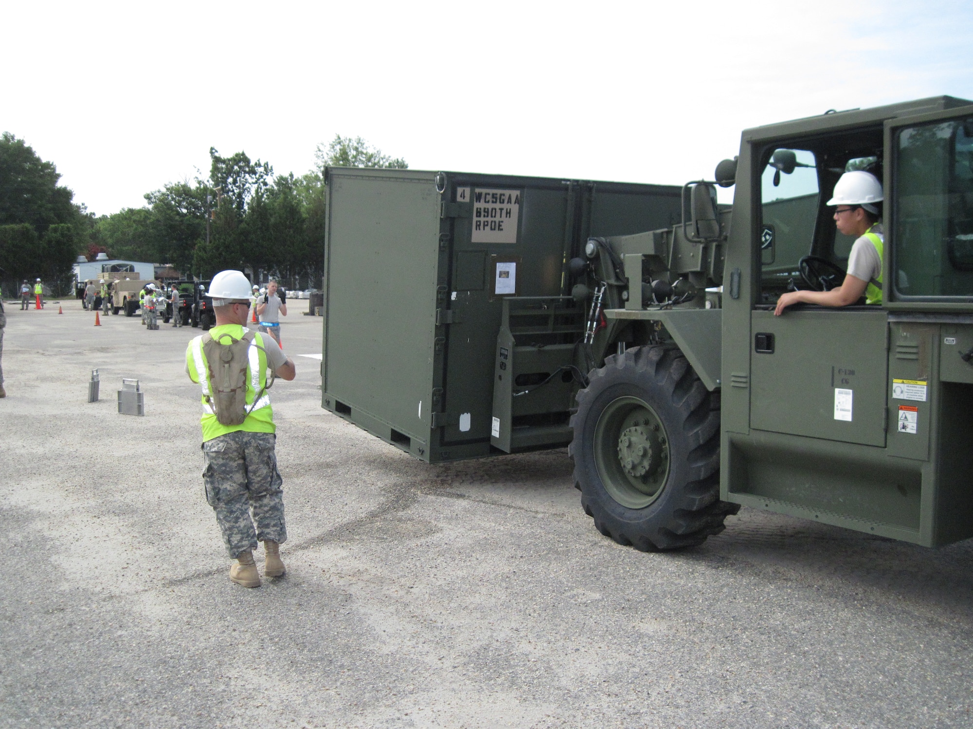 Members of the 690th Rapid Port Opening Element at Fort Eustis, Va., use a forklift to position an ISU-90 onto a set of portable scales Aug. 4. 2011. The joint, contingency-training exercise brought together Air Force and Army servicemembers for training. (U.S. Air Force Photo by Chief Master Sgt. Chris Alston/Released)