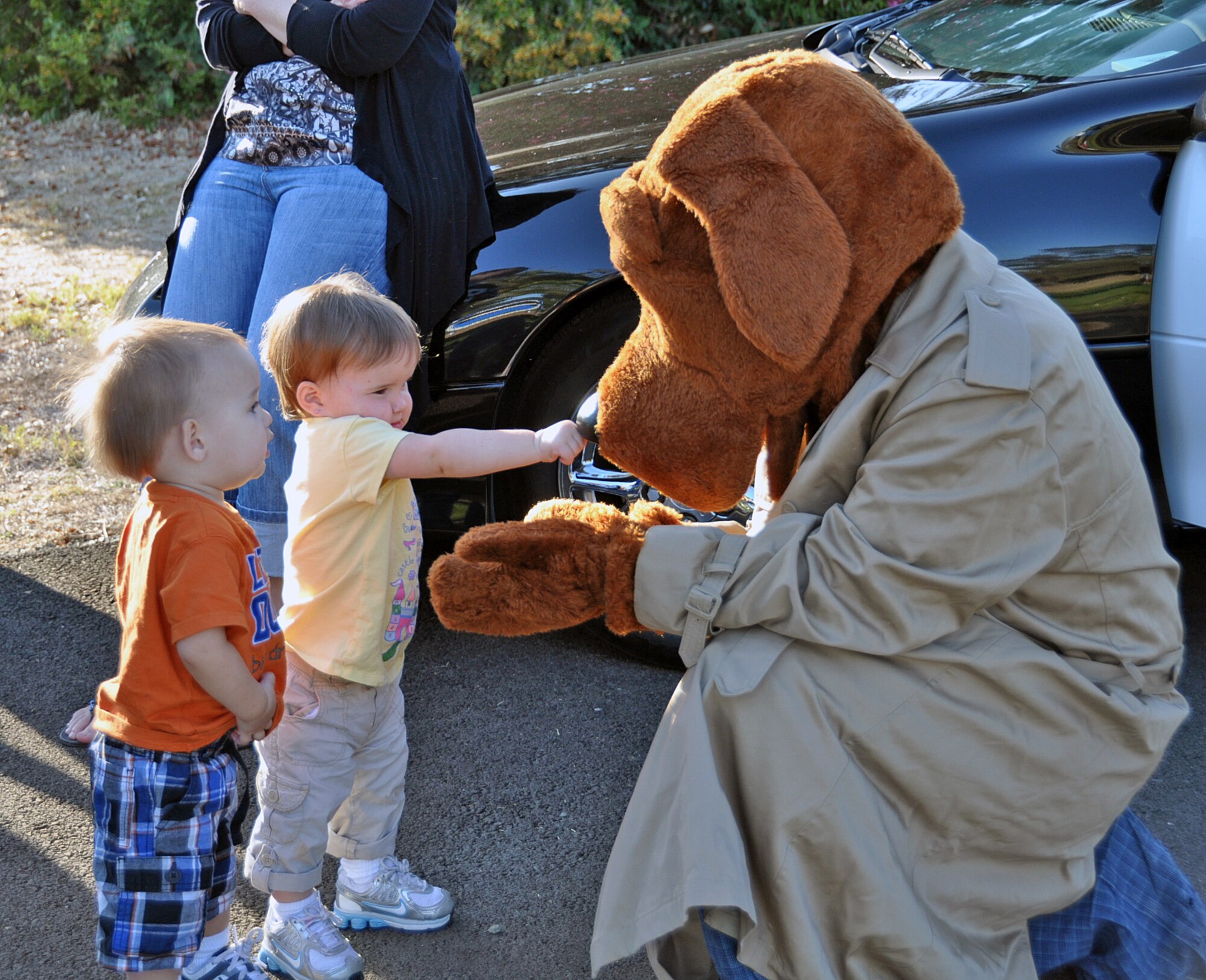 Madison Germain, 1, and William Germain, 1, meet Scruff McGruff Sept. 1 at the National Night Out event hosted by Balfour Beatty LifeWorks. (U.S. Air Force photo/ Airman Madelyn Ottem)