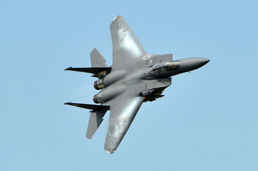 Speed combined with tight turn's cause's air to become visible and roll across the wings as the F-15E Strike Eagle Demo Team performs during the 2011 Defenders of Freedom Open House and Air Show at Offutt Air Force Base, Neb., Aug. 27. The F-15's maneuverability and acceleration are achieved through its high engine thrust-to-weight ratio and low-wing loading. (U.S. Air Force photo by Charles Haymond/Released)