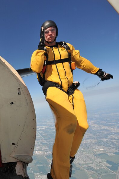 U.S. Army Sgt. Trevor Oppenborn, with the U.S. Army Golden Knights demonstration team, renders a salute as he jumps out the door of Fokker C-31A Troopship during the 2011 Defenders of Freedom Open House and Air Show at Offutt Air Force Base, Neb., Aug. 27.  The C-31A is used by the demonstration team as a jump platform while performing at more than 50 locations a year. (U.S. Air Force photo by Charles Haymond/Released)