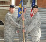 In a first ever 90th Security Forces Group triple change-of-command ceremony, Capt. Brent Gallant assumes command of the 90th Security Support Squadron from Capt. Kevin McMahon here Aug. 26. Col. Tom Wilcox, 90th SFG commander, is the presiding officer. (U.S. Air Force photo by Blaze Lipowski)
