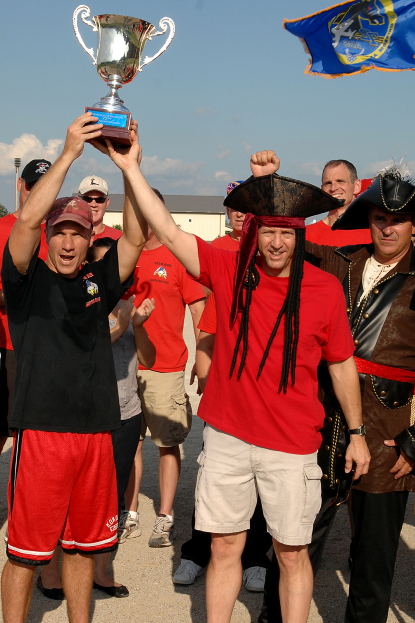 GRISSOM AIR RESERVE BASE, Ind. -- Dan Keeney and Brian Stopher hold up their trophy in celebration of their win during the 5th Annual Jovanovich Cup Aug. 13. Every year the Fightin' Red Tags and the Dark Side meet battle it out for the trophy and bragging rights. This year the Red Tags edged the Dark Siders, 13-12. The event is held in memory of Lt. Col. George Jovanovich who died in a car accident in March 2006. (U.S. Air Force photo/Senior Airman Jami K. Lancette) 