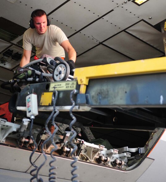 Air Force Senior Airman Eric Braun, 728th Air Mobility Squadron air transportation technician, offloads a stroller from an aircraft onto a conveyor belt Sept. 6, 2011, at Incirlik Air Base, Turkey. Braun is currently deployed here from the 86th Aerial Port Squadron, McChord Field, Wash., and volunteered to extend his tour at Incirlik by six months. (U.S. Air Force photo by Senior Airman Anthony Sanchelli)
