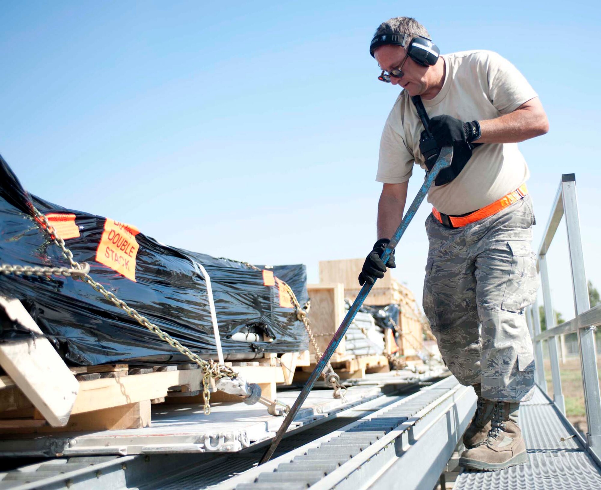 Air Force Staff Sgt. Daniel Wheeler, 728th Air Mobility Squadron, moves a pallet with a crowbar to straighten it out for a smoother transition to the K-loader, Sept. 6, 2011 at Incirlik Air Base, Turkey. Wheeler is currently deployed here from the 86th Aerial Port Squadron, McChord Field, Wash., and volunteered to extend his tour at Incirlik by six months. (U.S. Air Force photo by Senior Airman Clayton Lenhardt)