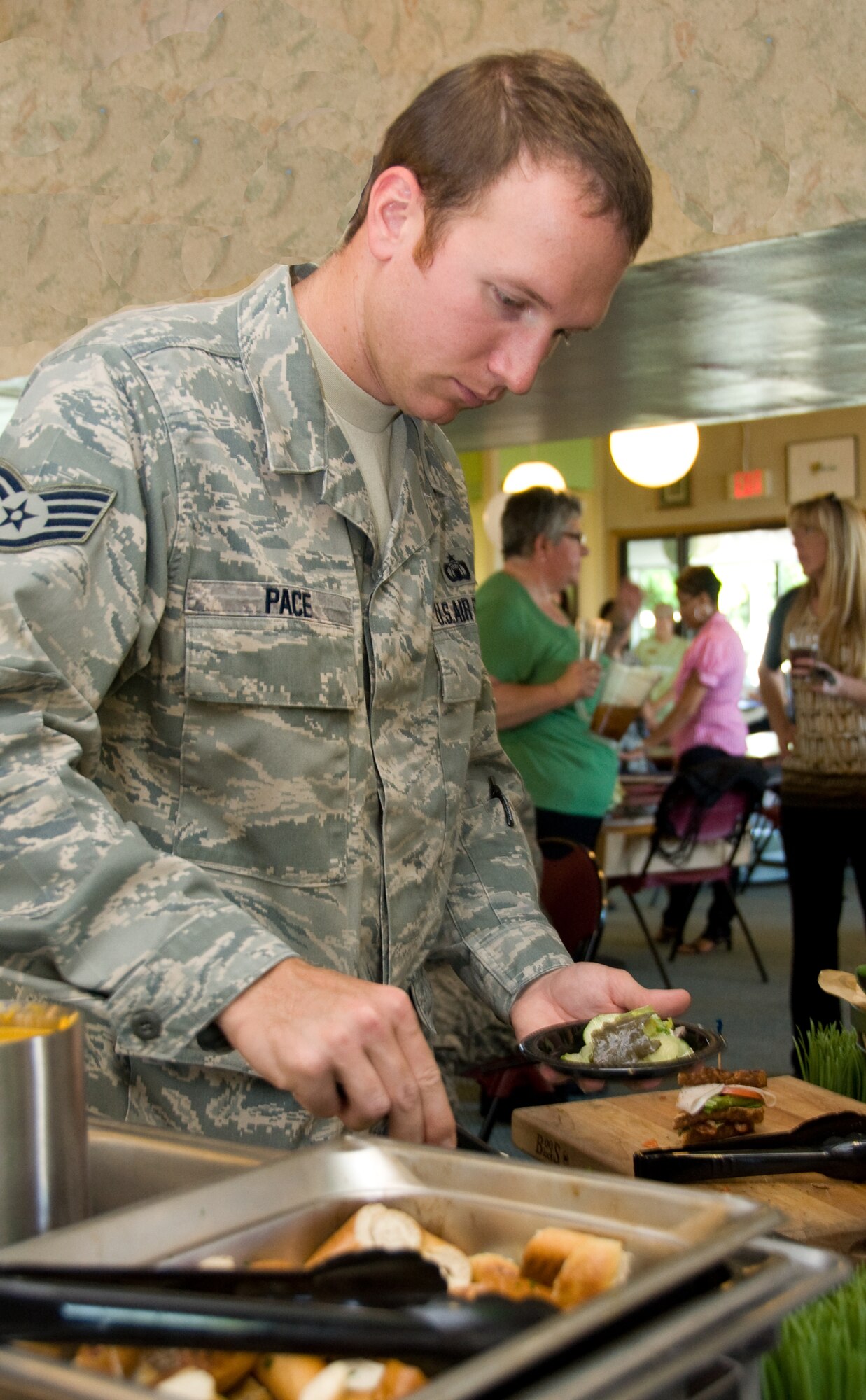 Staff Sgt. Derek Pace, 60th Operations Support Squadron, fills his plate at the sample bar Sept. 1 during the Fairways grand opening celebration at Cypress Lakes Golf Course. (U.S. Air Force photo/Staff Sgt. Timothy Boyer)