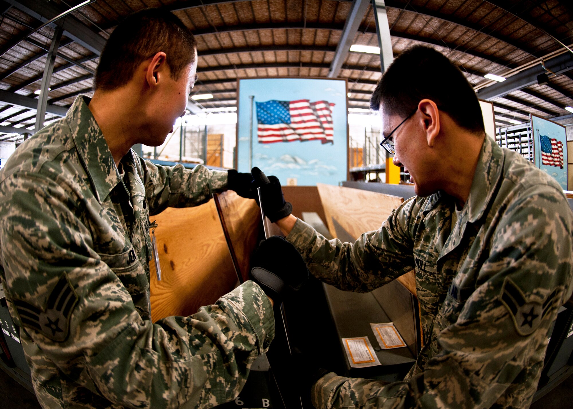 Airman 1st Class Andrew Hull and Senior Airman Ching Jen, 96th Materiel Management Flight, pull out a piece of sheet metal from Eglin's supply warehouse.  Eglin's materiel management flight is the largest supply flight in the U.S.  Approximately 125 military and civilian personnel manage more than 50,000 items valued at $875 million.  They also manage more than 300 nonexpendable equipment accounts tracking more than $700 million in assets spread across Eglin and other locations. The materiel management flight is part of the 96th Logistics Readiness Squadron.  (U.S. Air Force photo/Samuel King Jr.)