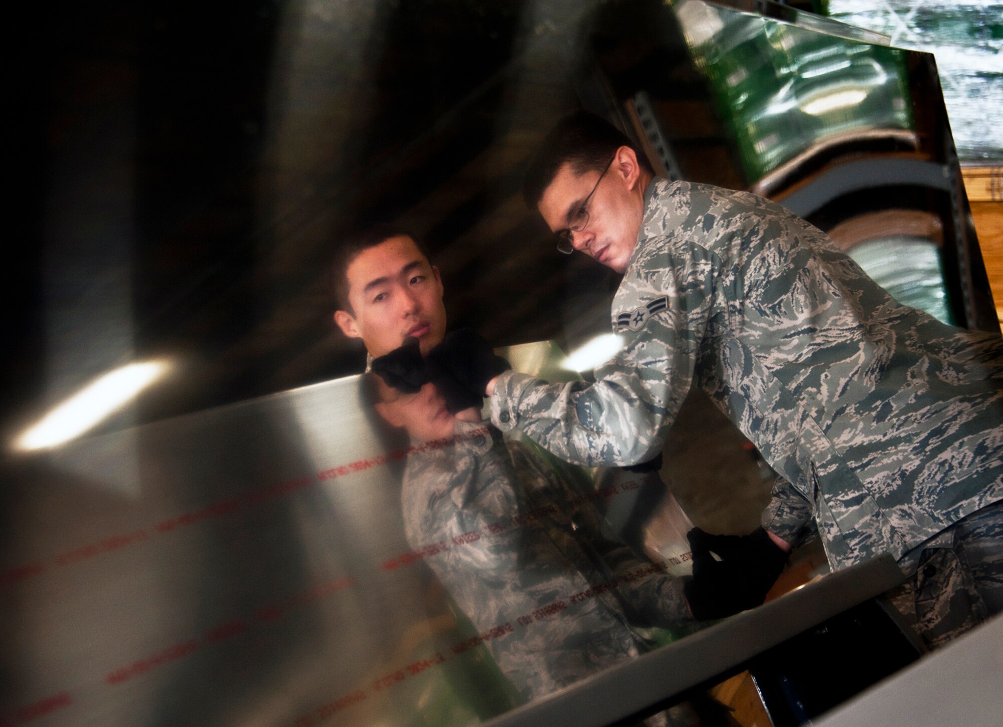 Airman 1st Class Andrew Hull and Senior Airman Ching Jen, 96th Materiel Management Flight, pull out a piece of sheet metal from Eglin's supply warehouse.  Eglin's materiel management flight is the largest supply flight in the U.S.  Approximately 125 military and civilian personnel manage more than 50,000 items valued at $875 million.  They also manage more than 300 nonexpendable equipment accounts tracking more than $700 million in assets spread across Eglin and other locations. The materiel management flight is part of the 96th Logistics Readiness Squadron.  (U.S. Air Force photo/Samuel King Jr.)