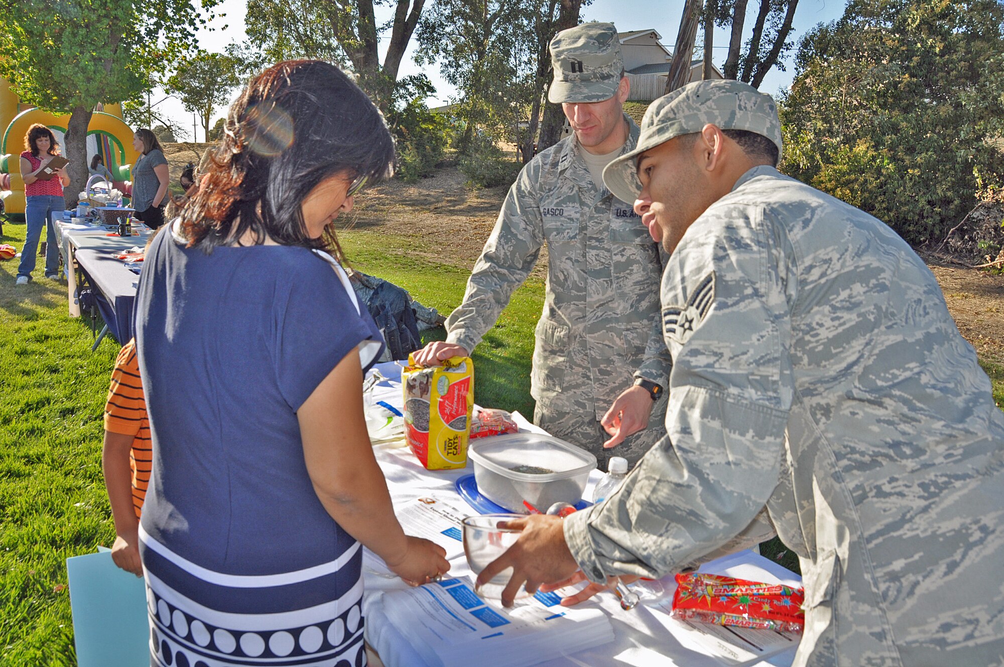 Capt. Luke Gasco, 60th Diagnostics and Therapeutics Squadron chief outpatient pharmacy services, and Senior Airman William Meadows-Marquez, 60th MDTS inpatient pharmacy technician, demostrate for the crowd hos to properly and safely dispose of unused medication. (U.S. Air Force photo/ Airman Madelyn Ottem)