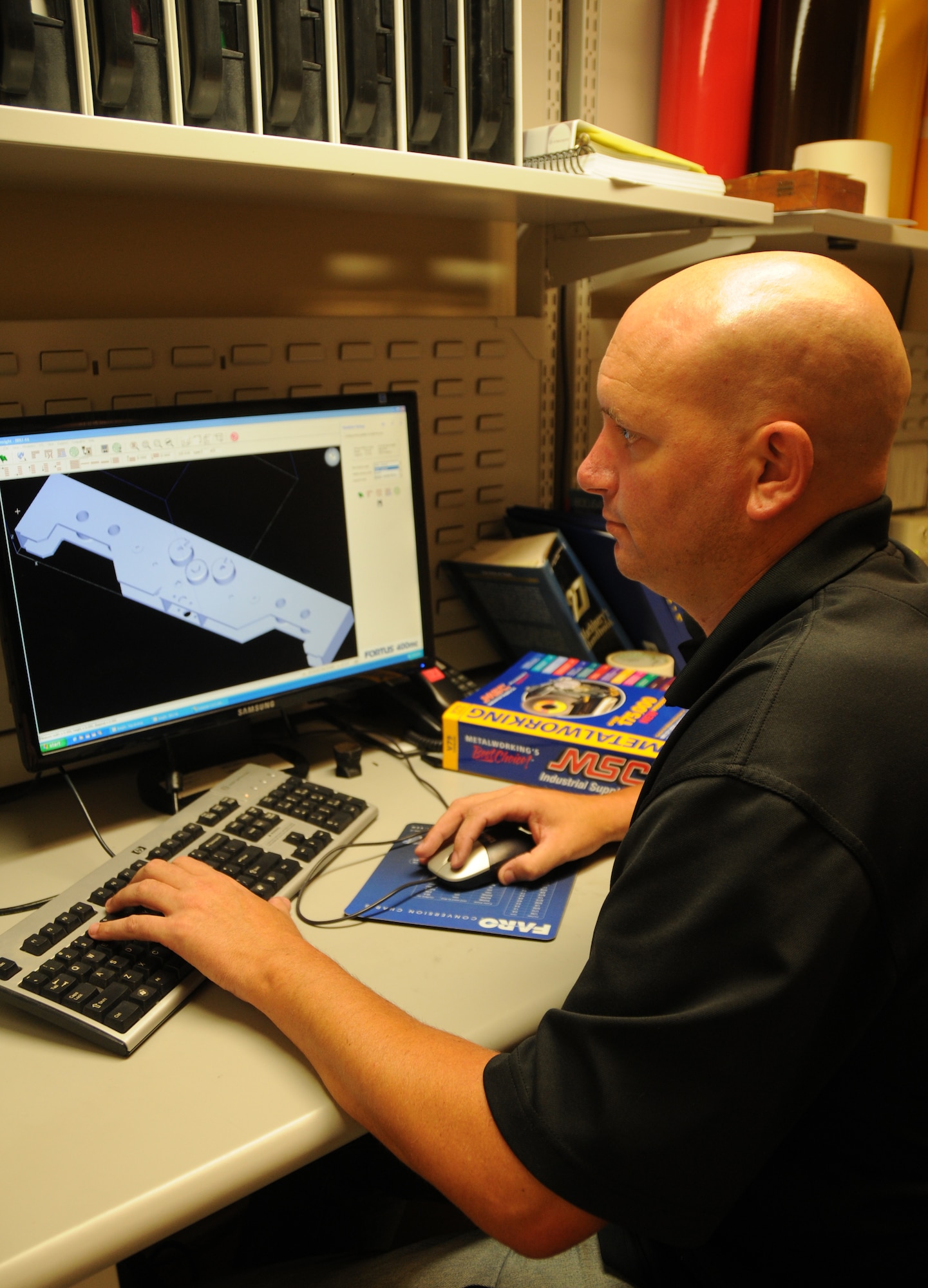 Heath Harris, a fabricator in the 81st Training Support Squadron trainer development
flight, manipulates an object using the 3-D modeling software Insight. Any  adjustments or corrections can be made here before sending the object to print. Trainer development has two 3-D printers used in the production of parts, prototypes and replicas of real items. These valuable assets are used in creating training simulators to help Keesler and other bases perform their training missions more effectively and economically. (U.S. Air Force photo by Kemberly Groue)