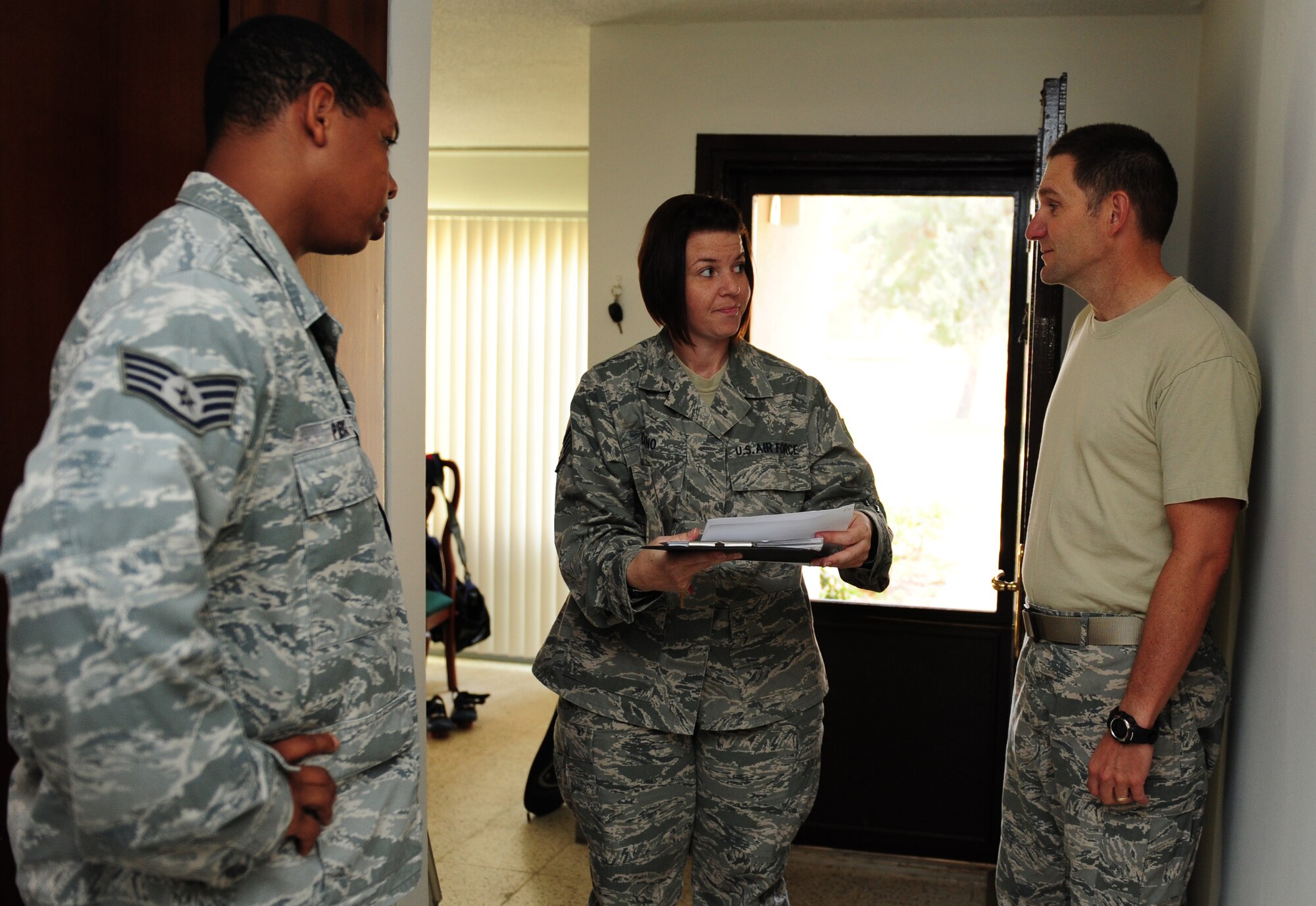 Staff Sgts. Marcus Pierce and Rose Ciano, 39th Civil Engineer Squadron dorm managers, review a housing outprocessing checklist with Lt. Col. Neal Fontana, 39th Air Base Wing chief of command post, Sept. 7, 2011, at Incirlik Air Base, Turkey. Dorm managers conduct dormitory room inspections and unaccompanied housing inspections with people inprocessing and outprocessing the base. (U.S. Air Force photo by Senior Airman Anthony Sanchelli/Released) 