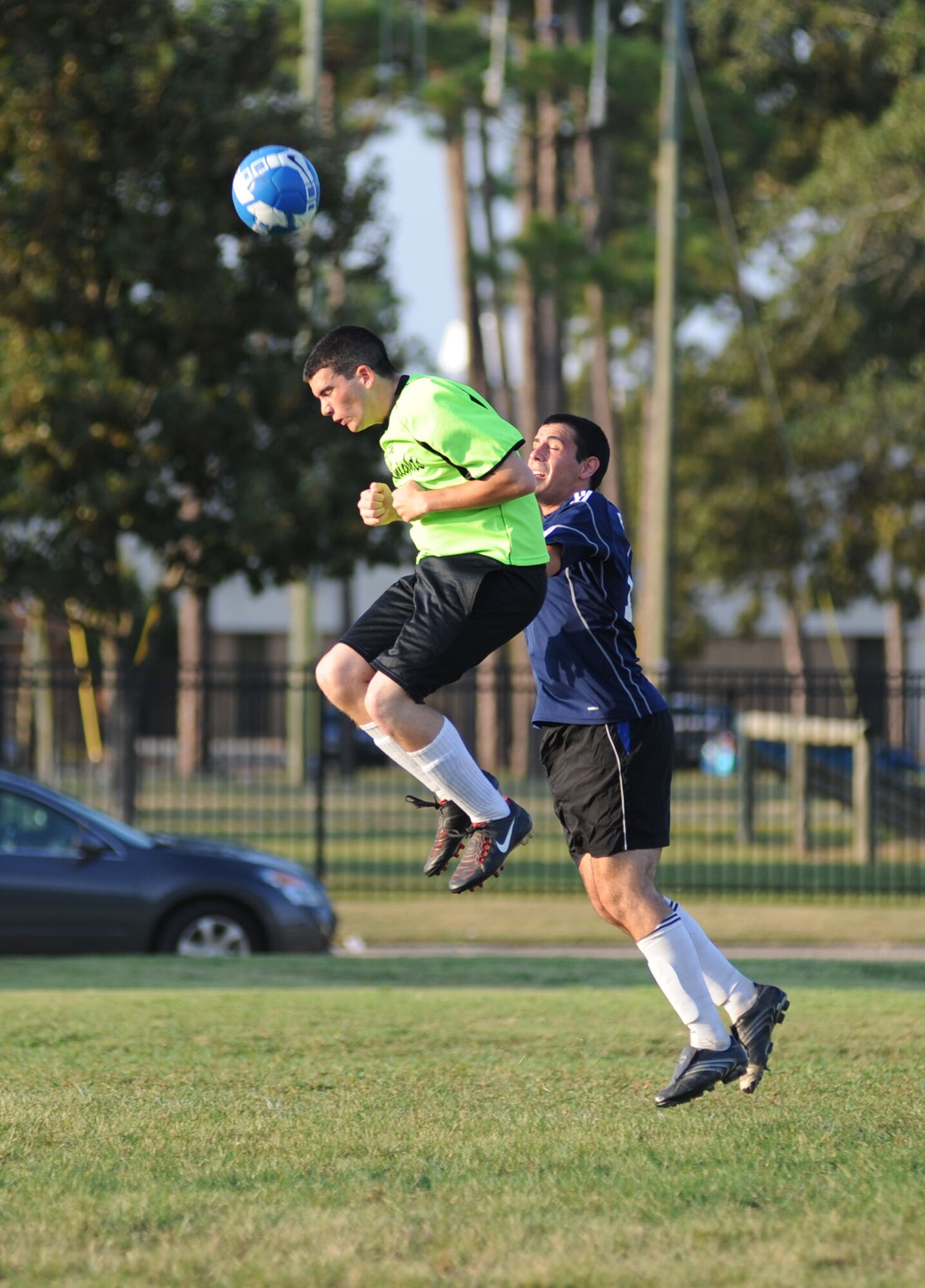 Calvin Robertson, 333rd Training Squadron, leaps up to head bump the ball to a teammate as Miguez Zapata, 333rd TRS, jumps up to defend during Keesler's intramural championship game, Aug. 31.  The 338th TRS won, 6-3.  (U.S. Air Force photo by Kemberly Groue)