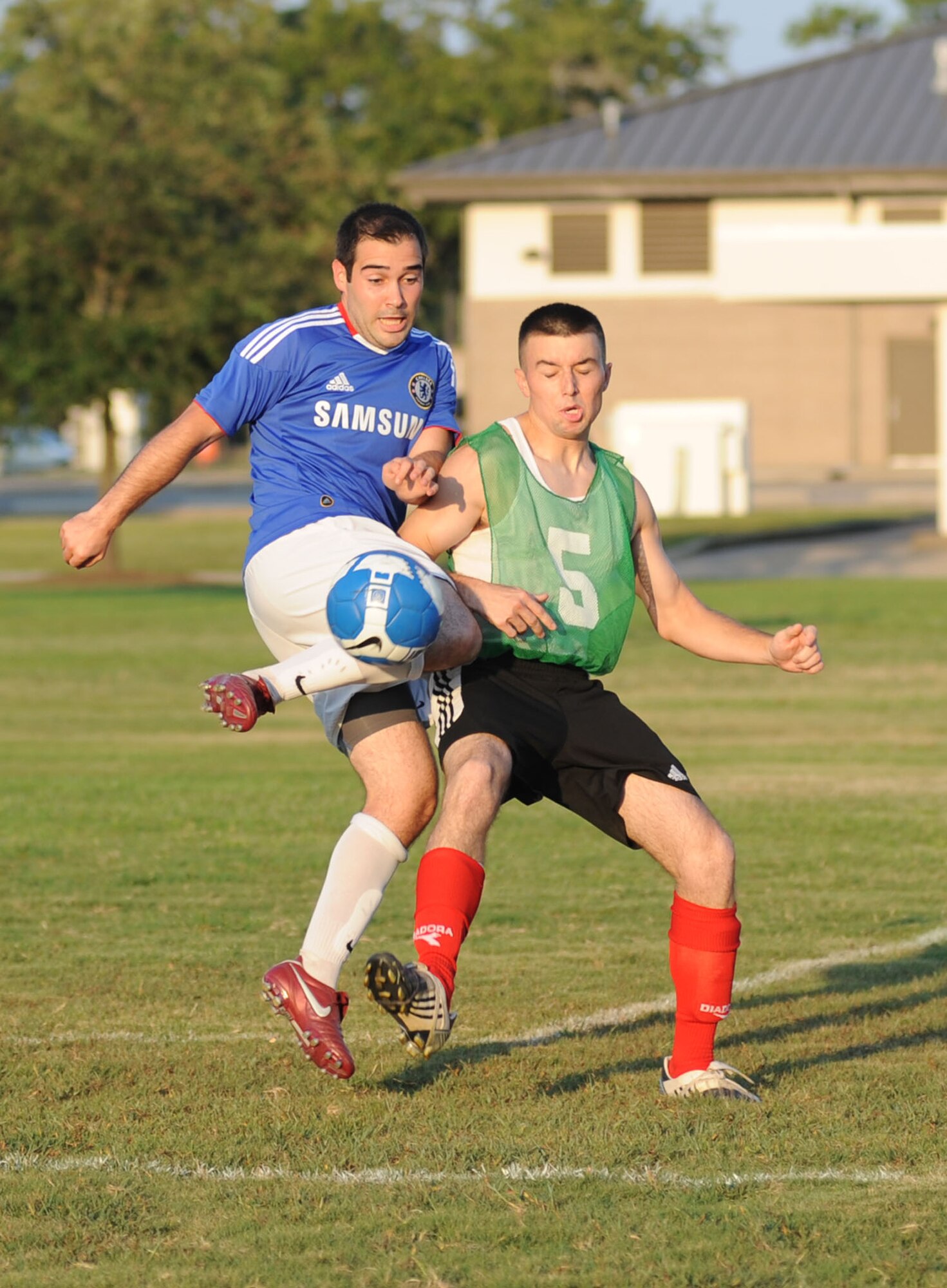 Jake Smeraglio, left, 333rd Training Squadron, gets his knee moving to keep the ball away from Dark Knight Zac Crula. The 338th TRS won the base championship with a 6-3 victory Aug. 31.  (U.S. Air Force photo by Kemberly Groue)