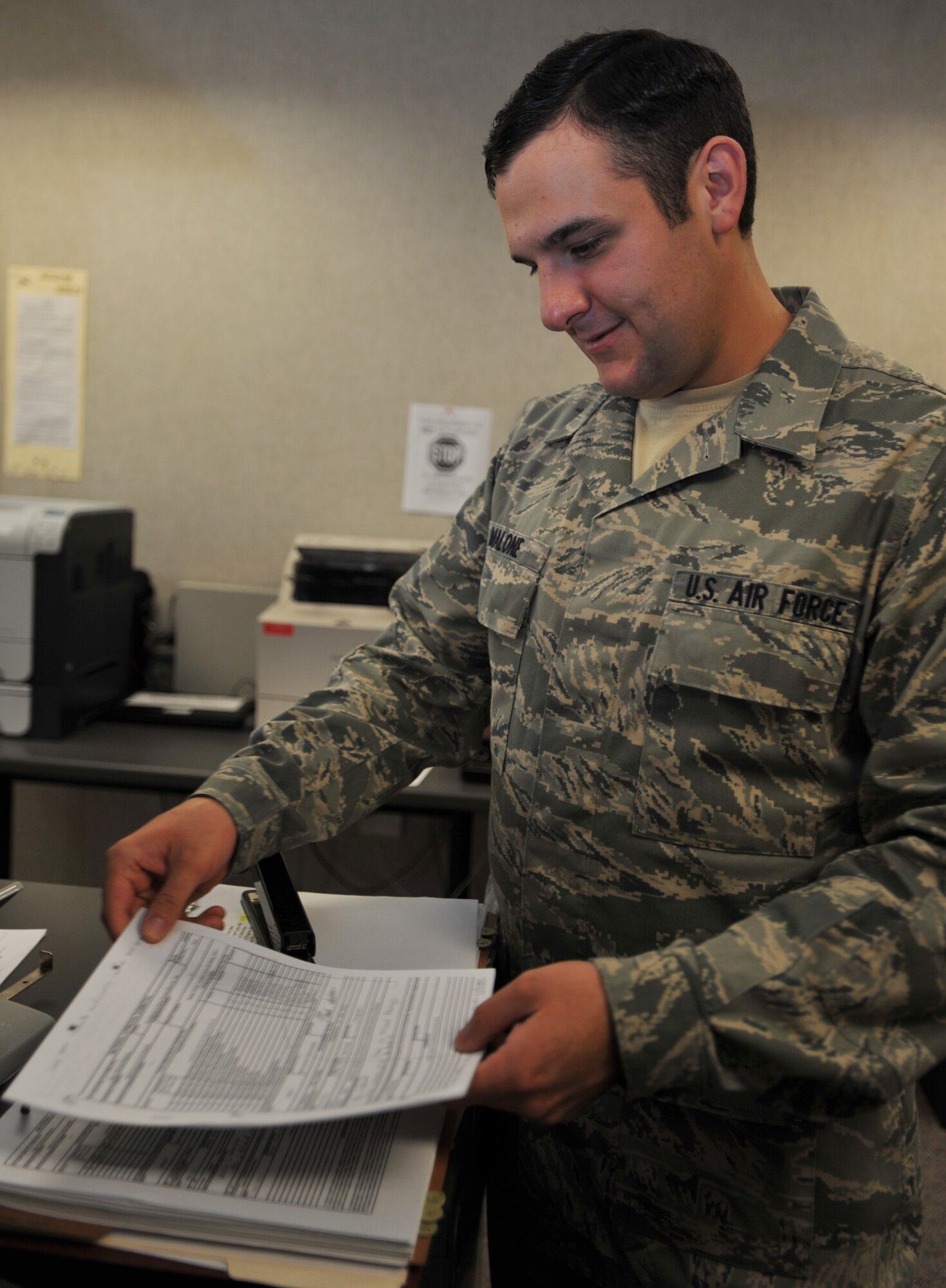 Airman 1st Class Dennis Malone, 22nd Contracting Squadron Construction Flight contract administrator, files materials in preparation for final payment on a contract Sept. 7, 2011, McConnell Air Force Base. The Hannibal, N.Y., native manages, performs and administers contracting functions for commodities, services and construction on McConnell. (U.S. Air Force photo by Airman 1st Class Laura L. Valentine) 