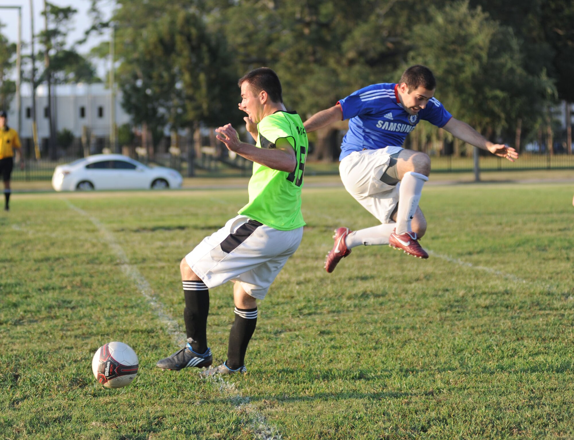 Derek Zimmer, left, takes control of the ball for the Dark Knights as Jake Smeraglio leaps past him to get to the ball during the championship game, Aug. 31.  (U.S. Air Force photo by Kemberly Groue)