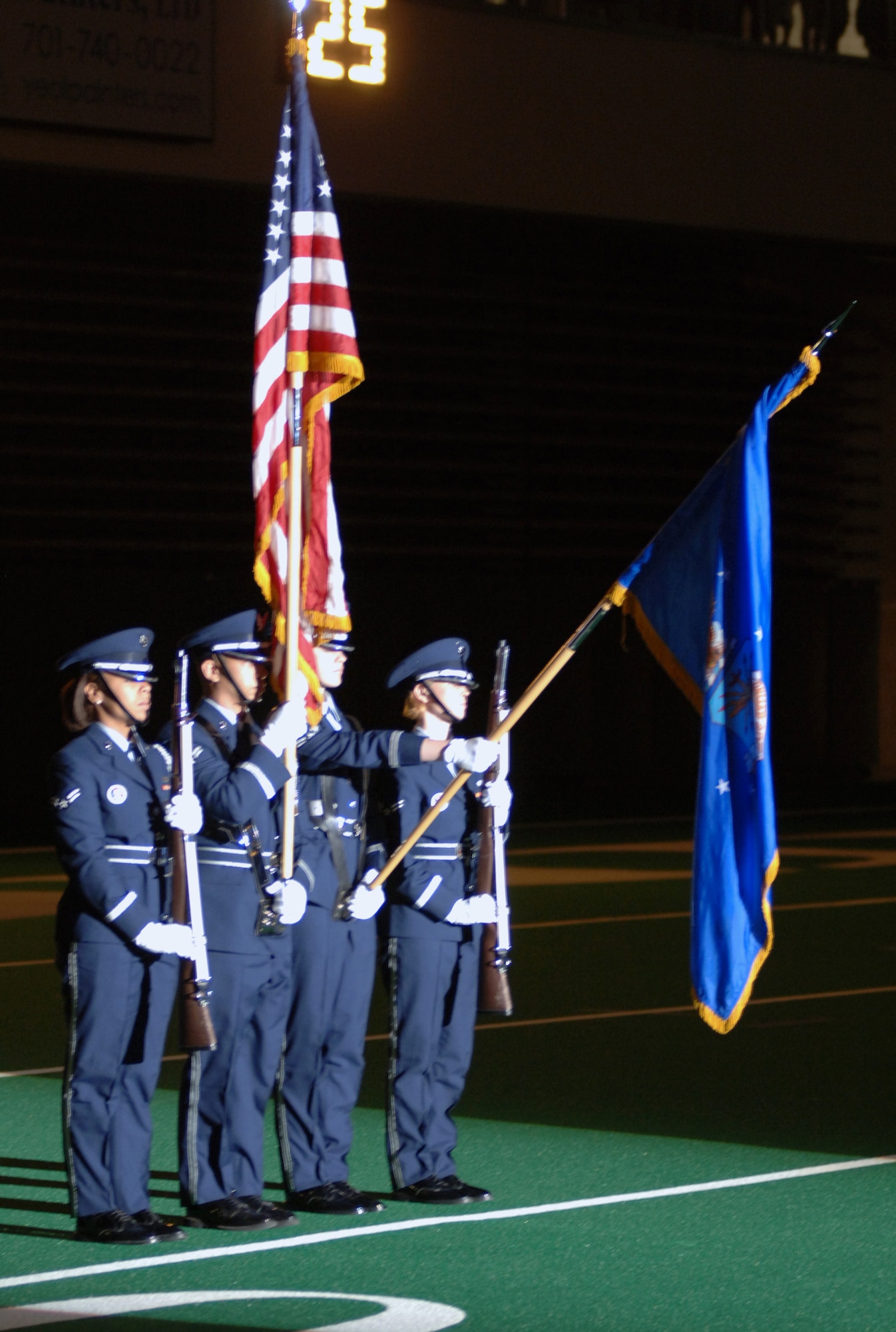 Color Guard Airmen from the 319th Air Base Wing at Grand Forks Air Force Base, N.D., march onto the field before a University of North Dakota versus Drake University football game on Sept. 1. Hundreds of servicemembers and their families were invited to attend the game for free as part of UND’s 14th Annual Maury Rothkopf Military Appreciation Day. (U.S. Air Force photo/Tim Flack)