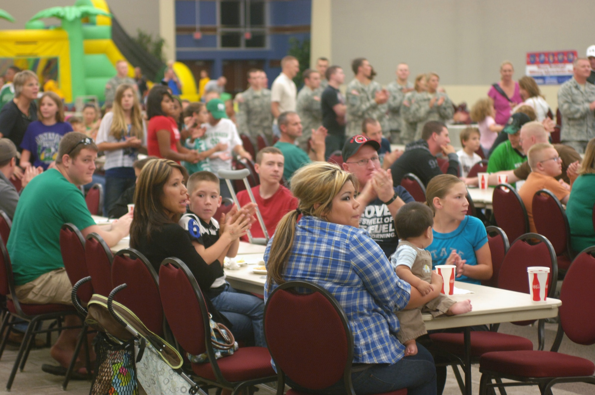 Servicemembers and their family members enjoy a free dinner prior to watching the University of North Dakota battle Drake University on the gridiron on Sept. 1. Dinner and the game were part of UND’s 14th Annual Maury Rothkopf Military Appreciation Day. (U.S. Air Force photo/Tim Flack)