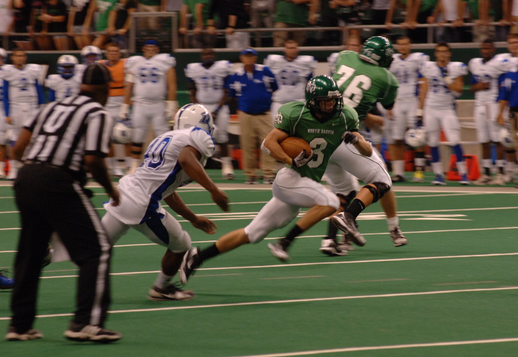A University of North Dakota football player races toward the end zone during a Sept. 1 game against Drake University. Hundreds of servicemembers and their family members were invited to the game to celebrate the school’s 14th Annual Maury Rothkopf Military Appreciation Day. (U.S. Air Force photo/Tim Flack)