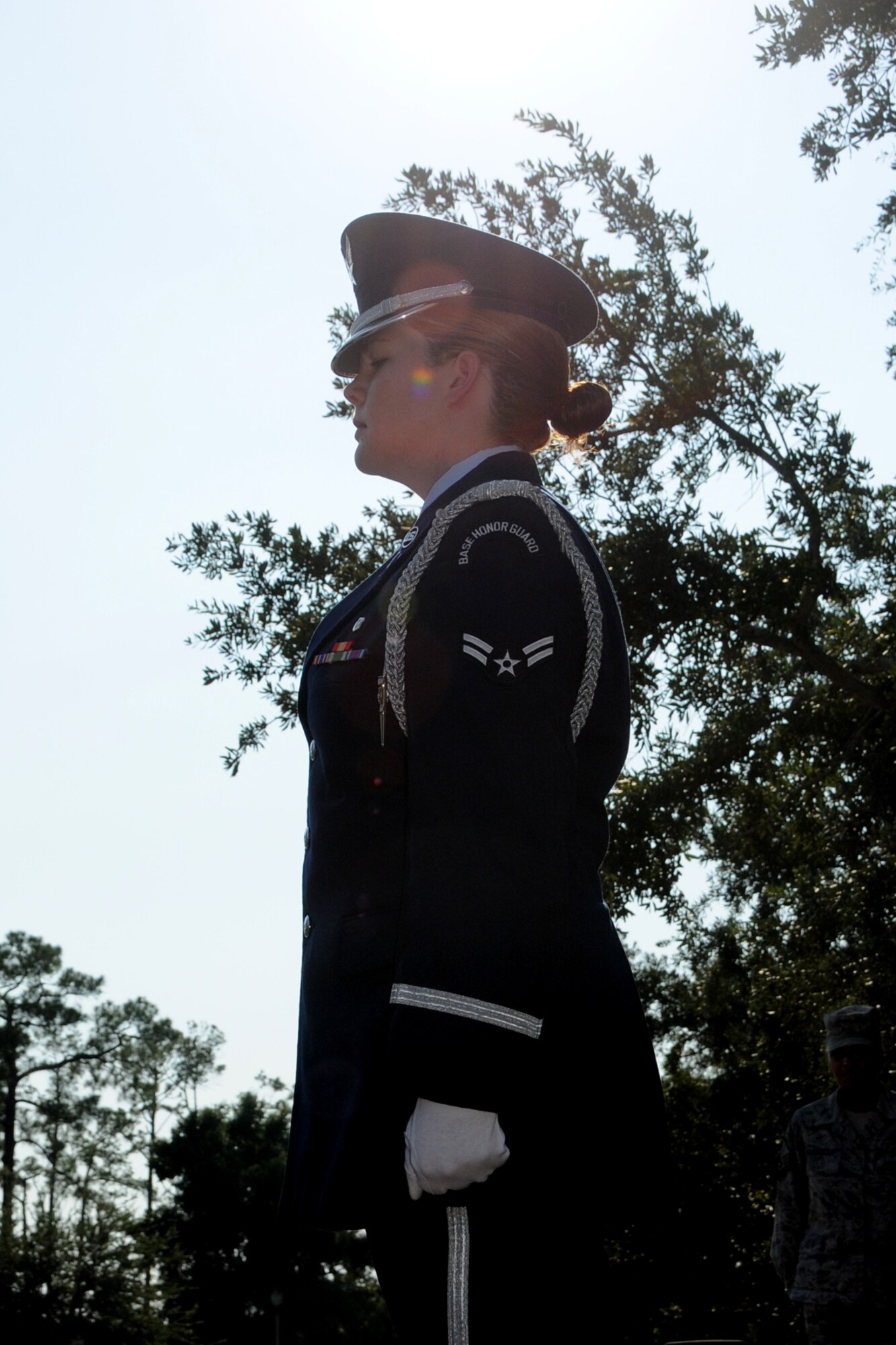 Members of the Keesler AFB Honor Guard fold the U.S. flag during a special retreat ceremony conducted Aug. 30 in front of the Keesler Hospital to honor former 81st Medical Group Commander retired Brig. Gen. (Dr.) Dan Locker, visible at the right side of the flag.  General Locker led the "Dragon Medics"  from July 1997-June 2002.  This was his first visit to the hospital since his  August 2002 retirement.  He was in the area attending the Society of Air Force Clinical Surgeons Symposium held at Biloxi's IP Casino Resort and Spa.  Honor guard members are, from left:  Airmen 1st Class Terrance Hill, 81st Aerospace Medicine Squadron; and Kayle Potts Parker, 81st Medical Operations Squadron; and Senior Airman Eriqa Cortez, 81st Diagnostics and Therapeutics Squadron.  (U.S. Air Force photo by Kemberly Groue)
