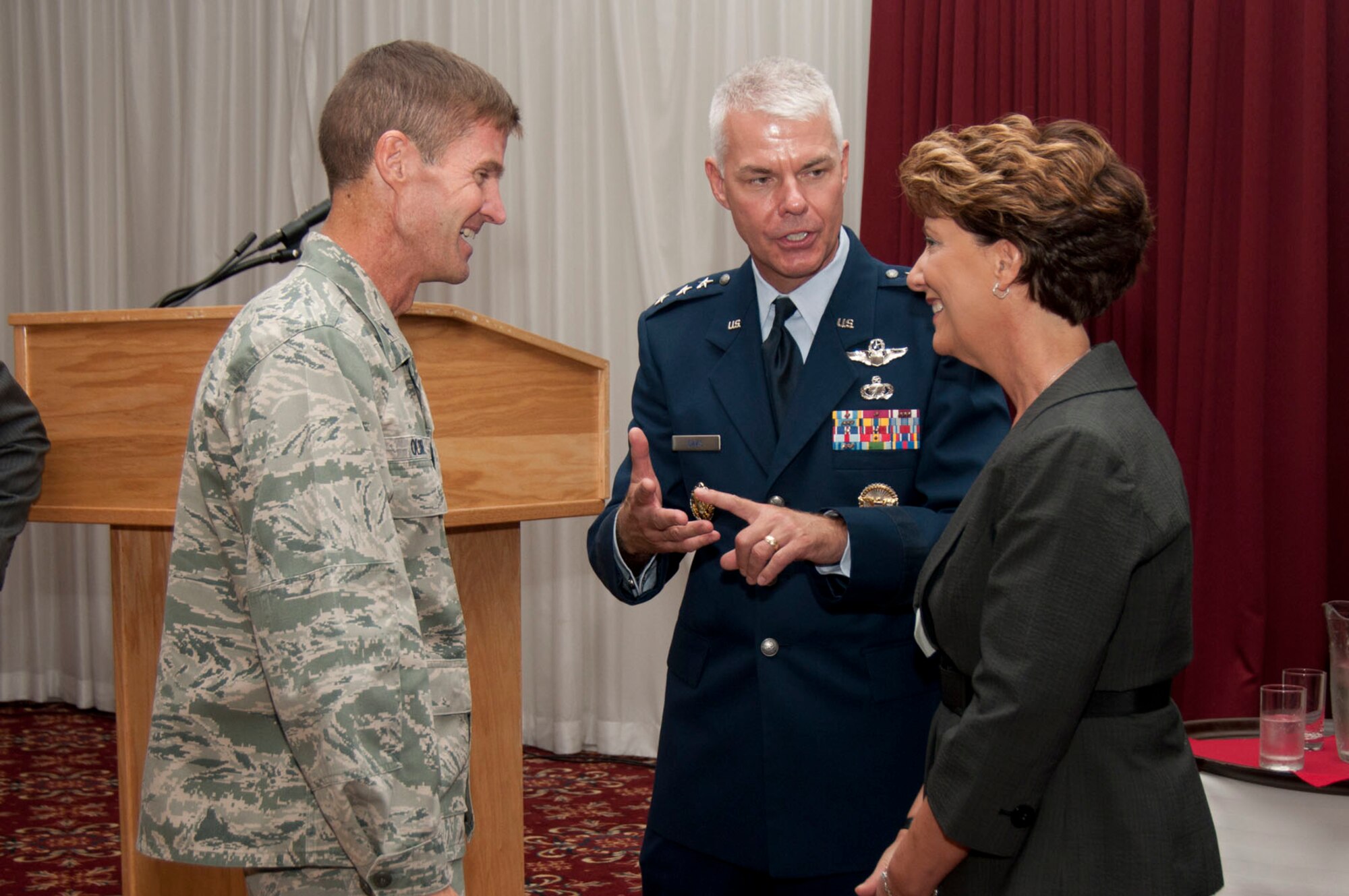 HANSCOM AIR FORCE BASE, Mass. - Brig Gen. Craig Olson (left), Air Force Business and Enterprise Systems program executive officer, speaks with Lt. Gen. Charles (C.R.) Davis, Electronic Systems Center commander, and his wife, Susan, during the ESC commander's welcome reception at the Minuteman Commons Sept. 1. (U.S. Air Force photo)
