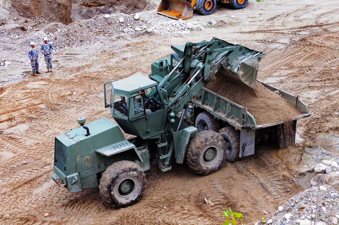 Maine Guardsmen load fill during engineering operations as part of cleanup efforts during the aftermath of Hurricane Irene in Pittsfield, Vt., Sept. 6, 2011.
