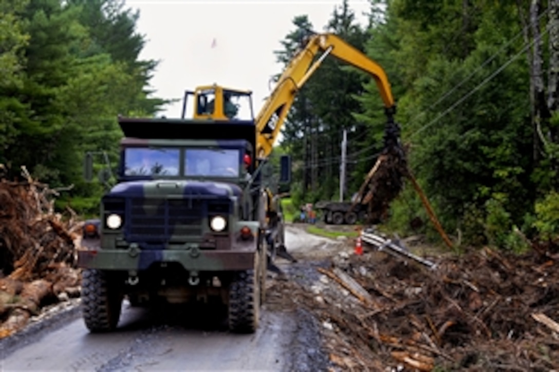 Soldiers work with civilians to clear debris from wires damaged by Hurricane Irene in Pittsfield, Vt., Sept. 6, 2011. Soldiers assigned to the Maine National Guard assisted the Vermont National Guard's Task Force Green Mountain Spirit in the effort.