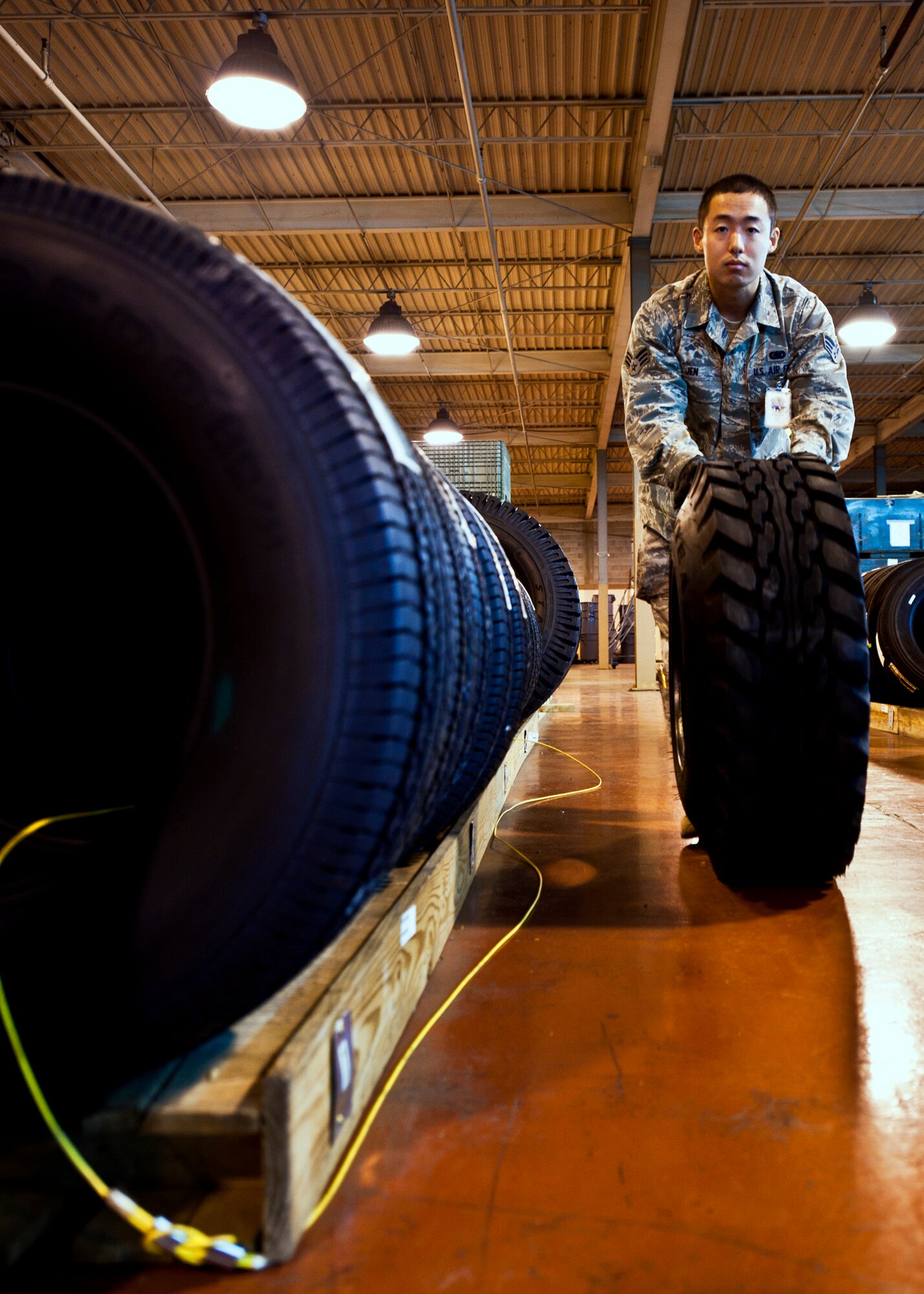 Senior Airman Ching Jen, 96th Materiel Management Flight, moves one of many tires through Eglin's supply warehouse.  Eglin's materiel management flight is the largest supply flight in the U.S.  Approximately 125 military and civilian personnel manage more than 50,000 items valued at $875 million.  They also manage more than 300 nonexpendable equipment accounts tracking more than $700 million in assets spread across Eglin and other locations. The materiel management flight is part of the 96th Logistics Readiness Squadron.  (U.S. Air Force photo/Samuel King Jr.)