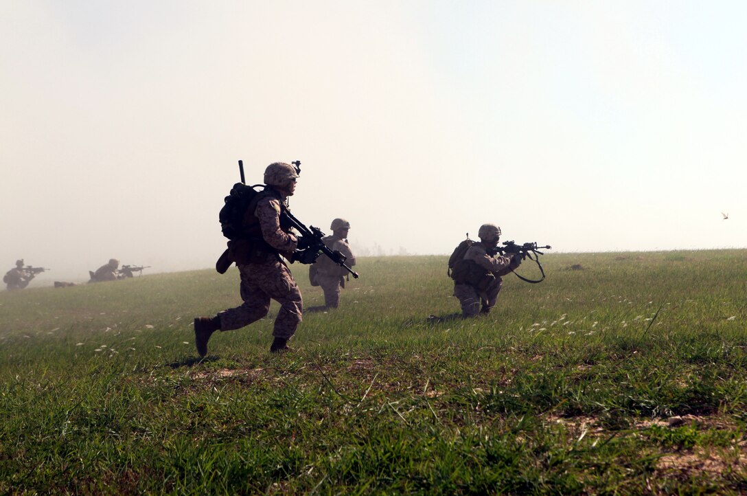 Marines from Company E, Battalion Landing Team 2nd Battalion, 7th Marines, 31st Marine Expeditionary Unit, assault the airfield here during a mock seizure, Sept. 9.  The helicopter raid exercise is part of a series of training events to prepare the 31st MEU for its upcoming deployment.
