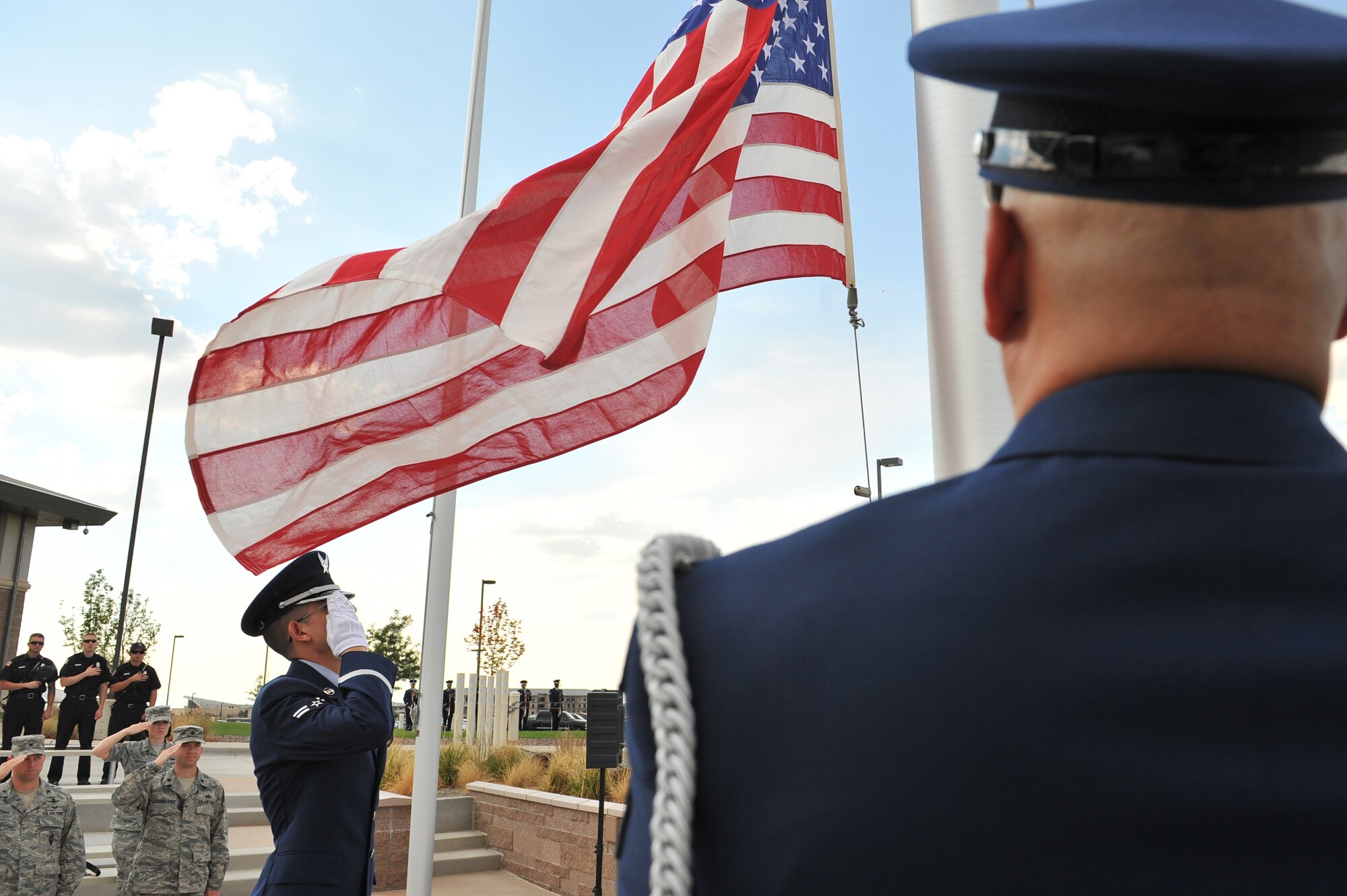 BUCKLEY AIR FORCE BASE, Colo. -- Mile High honor guardsmen lower the flag during retreat here Sept. 9, 2011. Team Buckley's Patriot Day Ceremony was held during retreat here to remember the victims of 9/11. (U.S. Air Force photo by Staff Sgt. Kathrine McDowell)  
