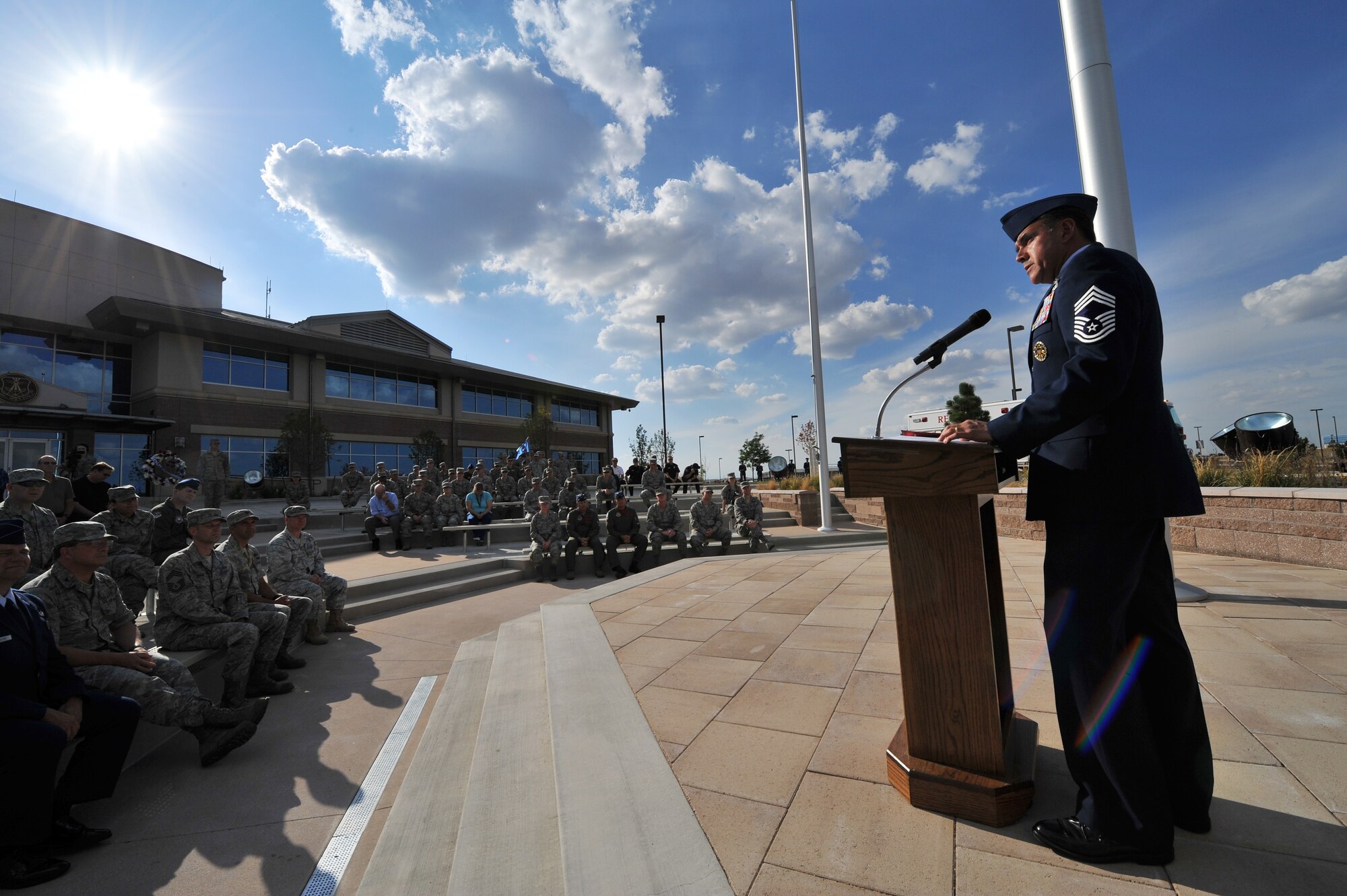 BUCKLEY AIR FORCE BASE, Colo. -- Chief Master Sgt. Mark Harper, 460th Operations Group, serves as guest speaker for Team Buckley's observance of Patriot Day Sept. 9, 2011. Harper asked all attendees to remember the innocent that died in the 9/11 attacks and reflect on how tragedy has bound us all to overcome. (U.S. Air Force photo by Staff Sgt. Kathrine McDowell)  