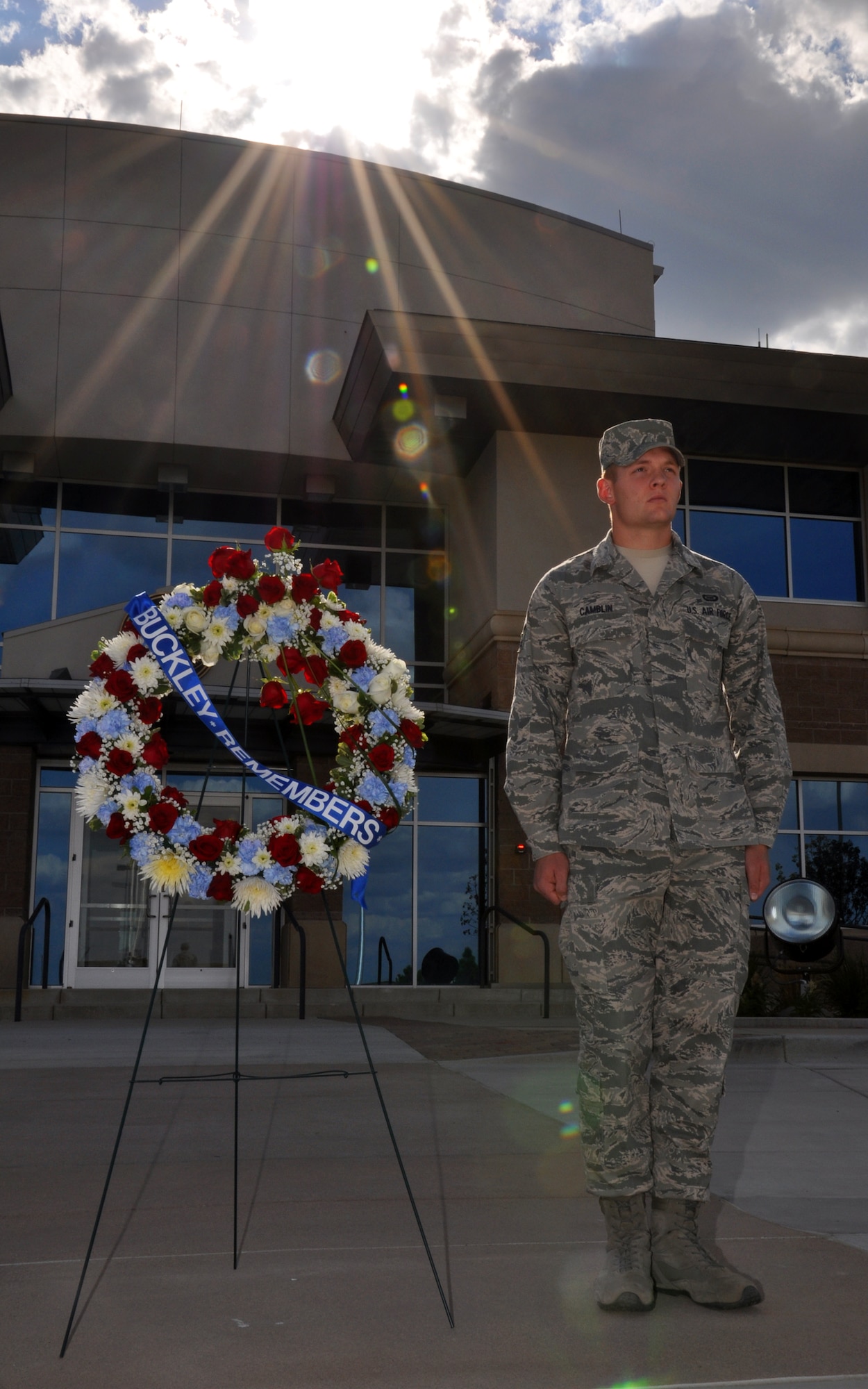 BUCKLEY AIR FORCE BASE, Colo. -- The sun sets as Airman 1st Class Robert Camblin, 460th Operations Group Intelligence, stands in memory of the 9/11 victims Sept. 9, 2011. On Sept. 11, 2001, Americans lost 2,976 of our civilian and military brothers and sisters. (U.S. Air Force photo by 2nd Lt. Rachel Freeman)