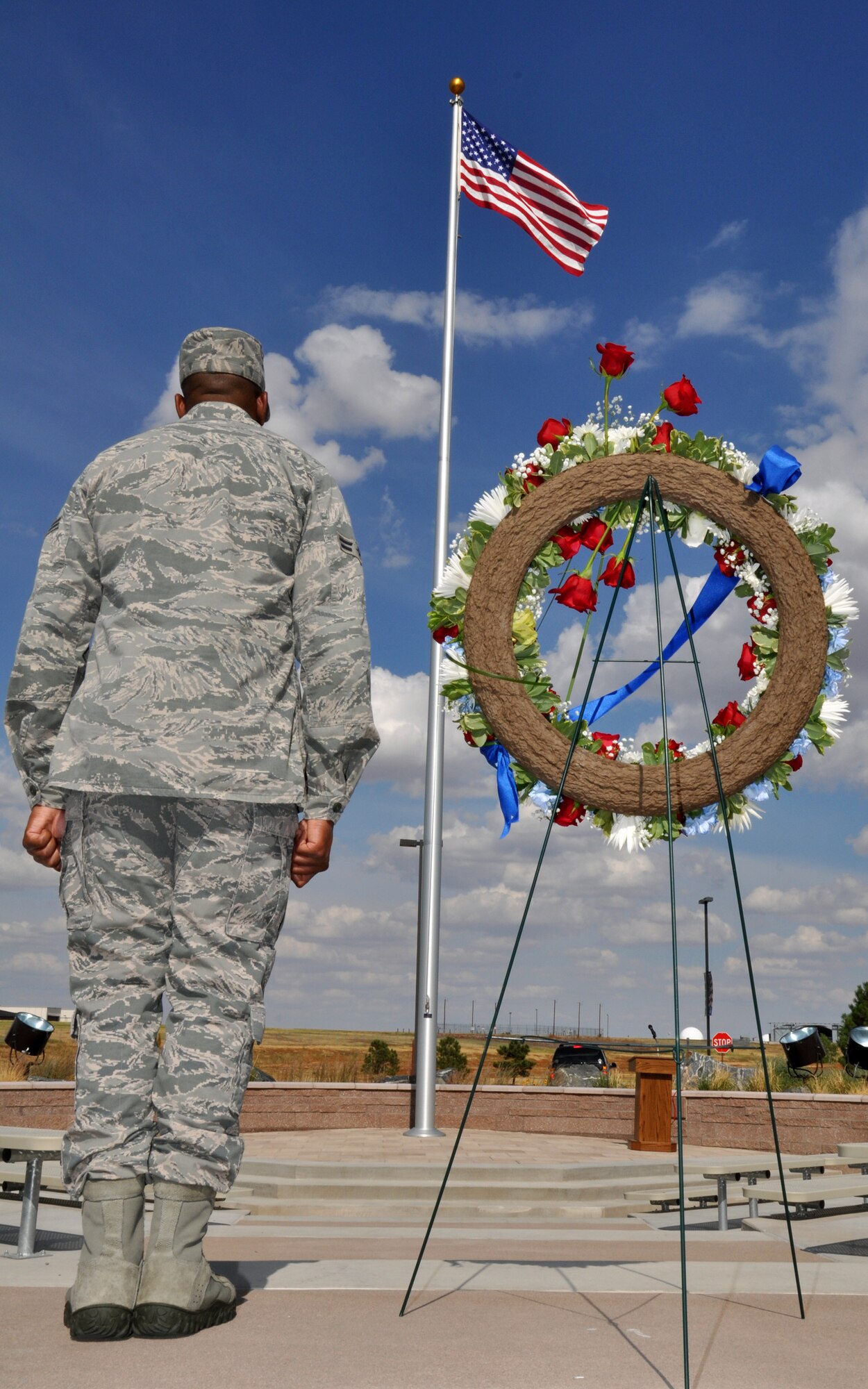 BUCKLEY AIR FORCE BASE, Colo. -- Airman 1st Class Waddell Howard, 460th Operations Group, honors the fallen in front of the base flag Sept. 9, 2011. Acting as silent guardians at Buckley's Patriot Day vigil, members stood watch in 30 minute shifts starting at 8:46 a.m.(U.S. Air Force photo by 2nd Lt. Rachel Freeman)