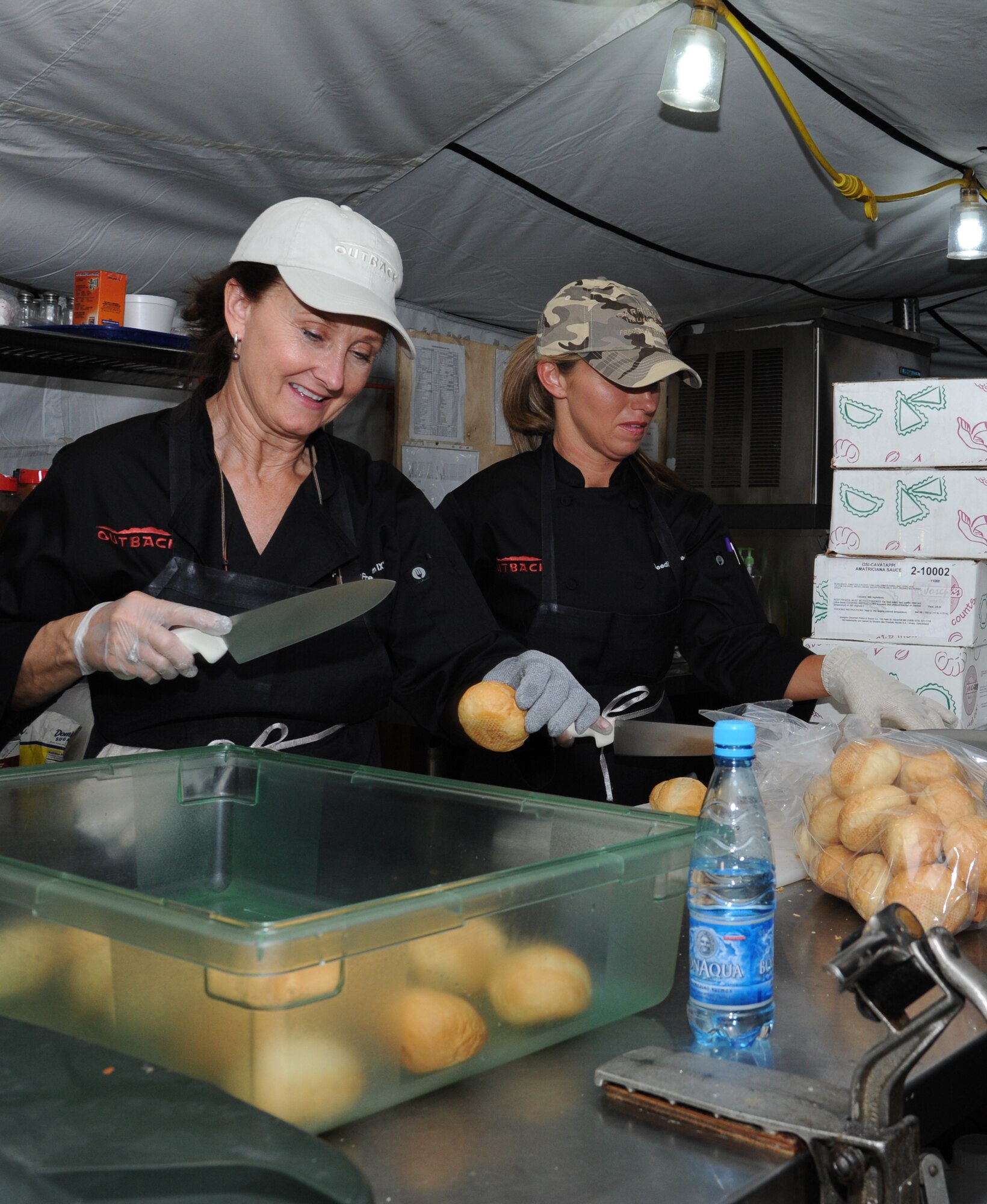 Arlene McCullum, left, and Becky Boyd, Outback Steakhouse Inc. employees, prepare rolls at Colonel Mac's dining facility as part of Operation Feeding Freedom IX at the Transit Center at Manas, Kyrgyzstan, Sept. 5. Operation Feeding Freedom launched in 2002 when a team of Outback employees traveled to Afghanistan to prepare a meal for service members deployed there. (U.S. Air Force photo/Tech. Sgt. Hank Hoegen)  