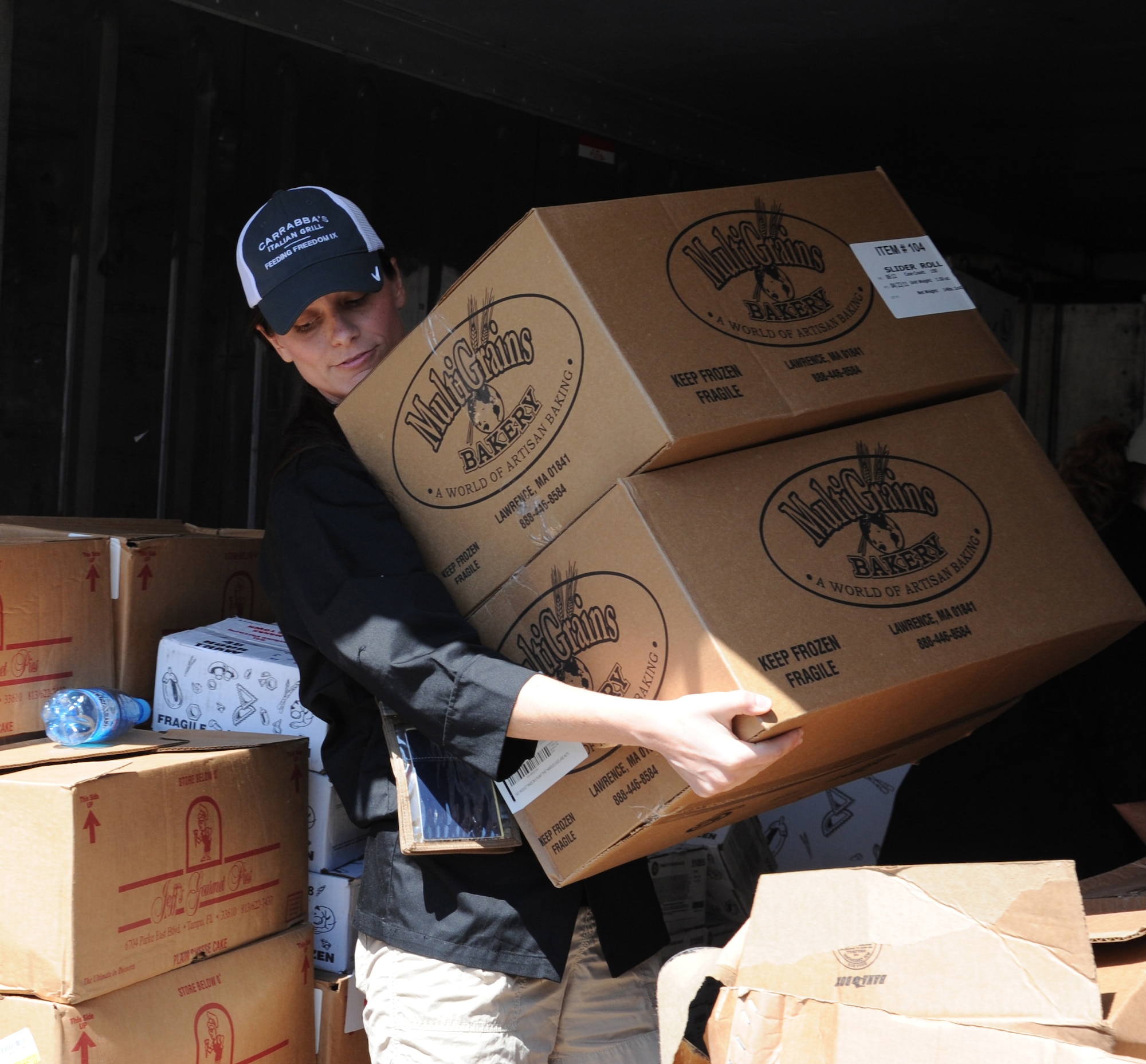 Sharen Robinson, Outback Steakhouse Inc. employee, carries supplies to begin preparations for dinner at the main dining facility as part of Operation Feeding Freedom IX at the Transit Center at Manas, Kyrgyzstan, Sept. 5. The employees prepared signature menu items like the Bloomin’ Onion, cavatappi amatriciana, chargrilled steaks, ravioli and cheesecake. (U.S. Air Force photo/Tech. Sgt. Hank Hoegen)  