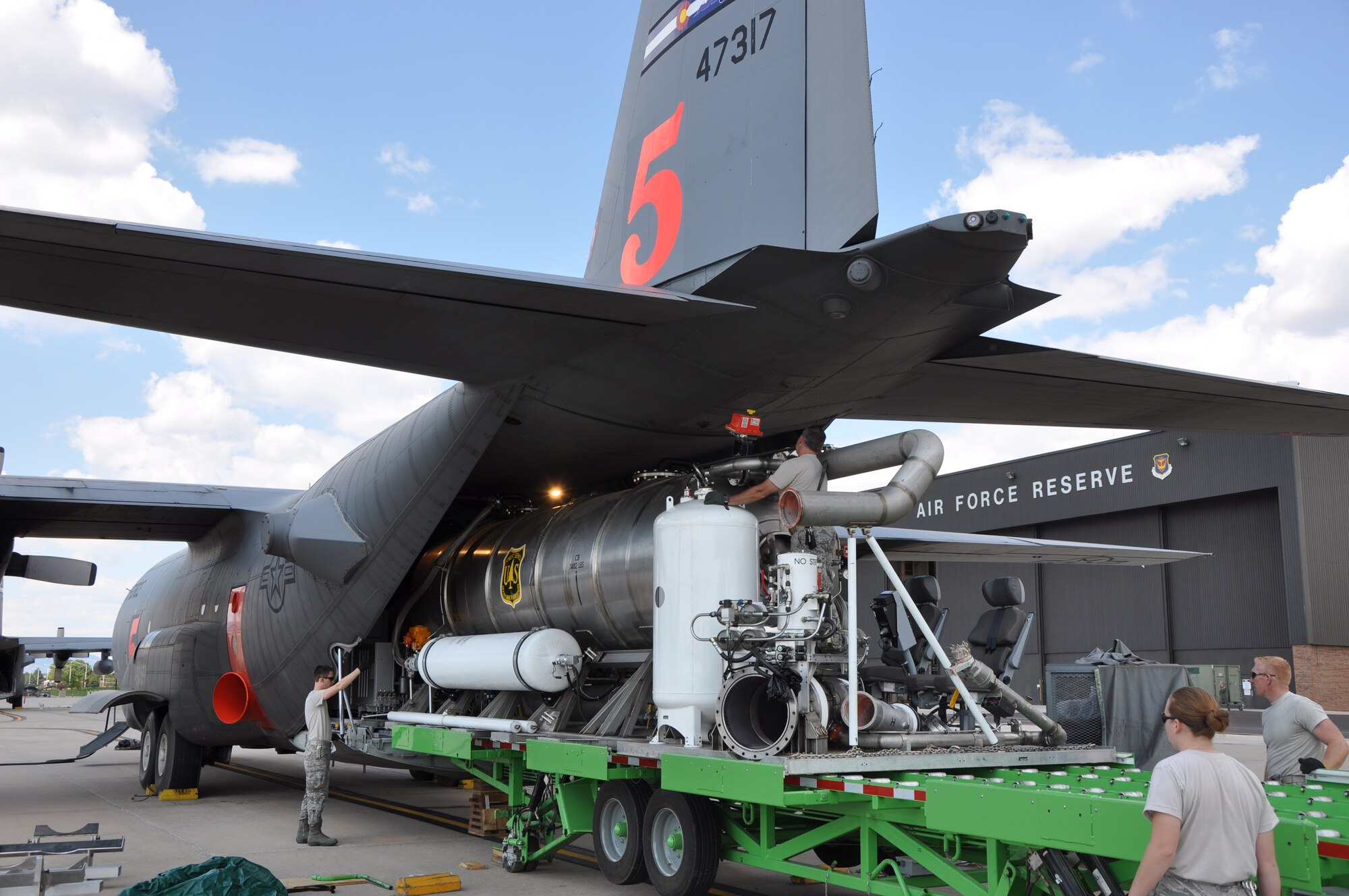 A U.S. Forest Service Modular Airborne Fire Fighting System II (MAFFS II) unit is loaded on to an Air Force Reserve Command C-130 Sept. 9 at Peterson Air Force Base, Colo. in preparation for support of aerial firefighting missions in Texas.  Four Air Reserve Component MAFFS-equipped C-130s and crews have been tasked by U.S. Northern Command in support of the National Interagency Fire Center to supplement wildland firefighting efforts in Texas. Two C-130s from the 302nd Airlift Wing, stationed at Peterson AFB, Colo. and two C-130s from the 145th Airlift Wing of the North Carolina Air National Guard will deploy to Austin, Texas.  