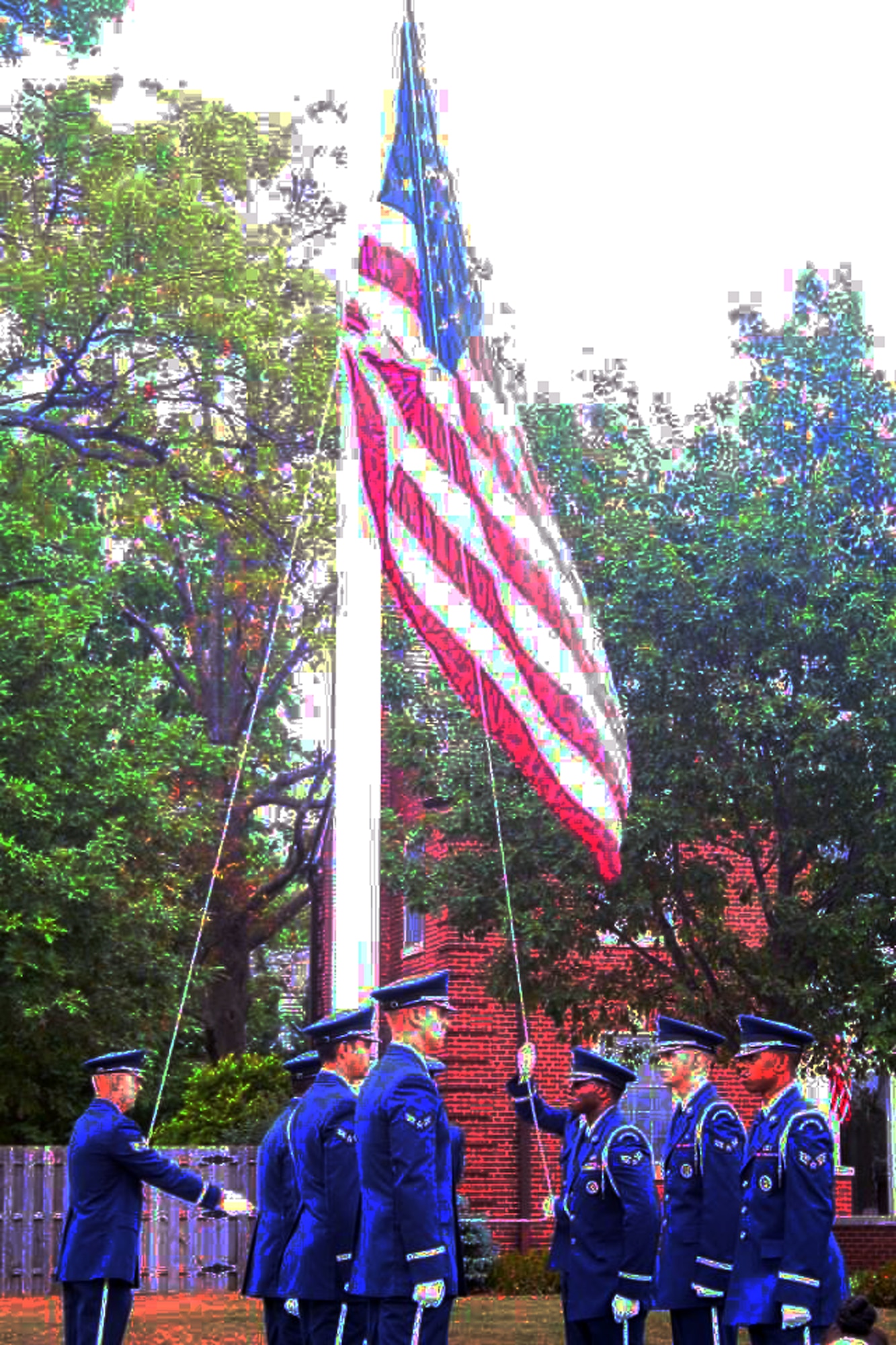 Members of the base honor guard lower the American flag Sept. 9, 2011, at Scott Air Force Base, Ill., during a retreat ceremony recognizing the 10th anniversary of the Sept. 11, 2001, attacks. (U.S. Air Force Photo Illustration/Master Sgt. Scott T. Sturkol) 