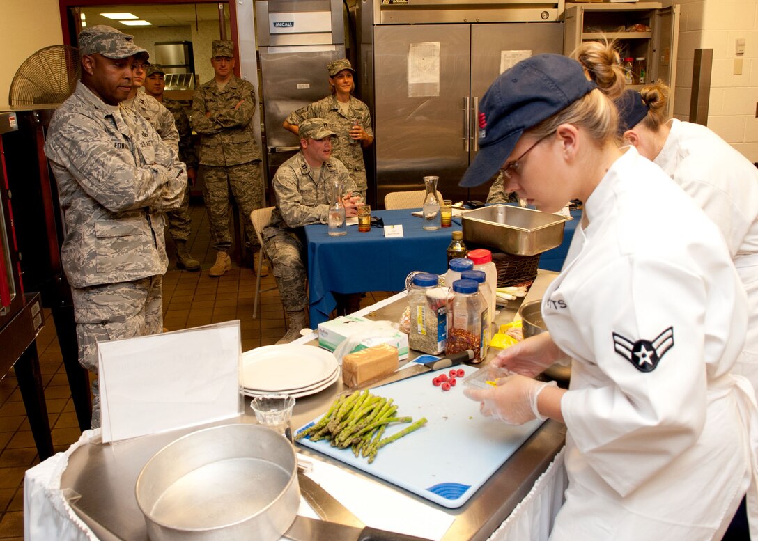 Col. Trent Edwards, 28th Mission Support Group commander, looks on while contestants compete during the Ellsworth Iron Chef competition at the Bandit Inn dining facility, Ellsworth Air Force Base, S.D., Aug. 26, 2011. Col Edwards was one of three judges that scored each meal on taste, creativity and presentation. (U.S. Air Force photo/Tech. Sgt. Jerry Fleshman/Released)
