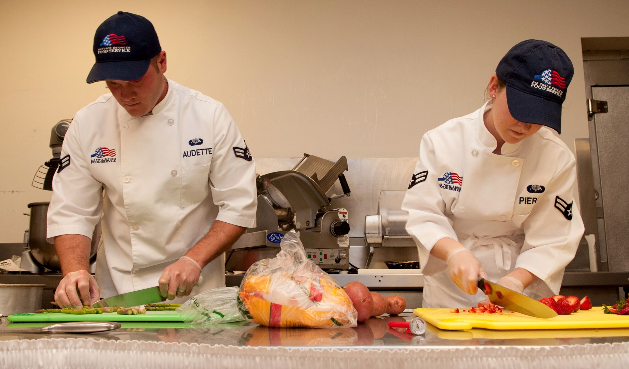 Airmen 1st Class Reese Audette and Nichole Pierce, 28th Force Support Squadron food services apprentices, chop up fruits and vegetables during the Ellsworth Iron Chef competition at the Bandit Inn dining facility, Ellsworth Air Force Base, S.D., Aug. 26, 2011. Audette and Pierce were runners up in the one-hour competition. (U.S. Air Force photo/Tech. Sgt. Jerry Fleshman/Released)